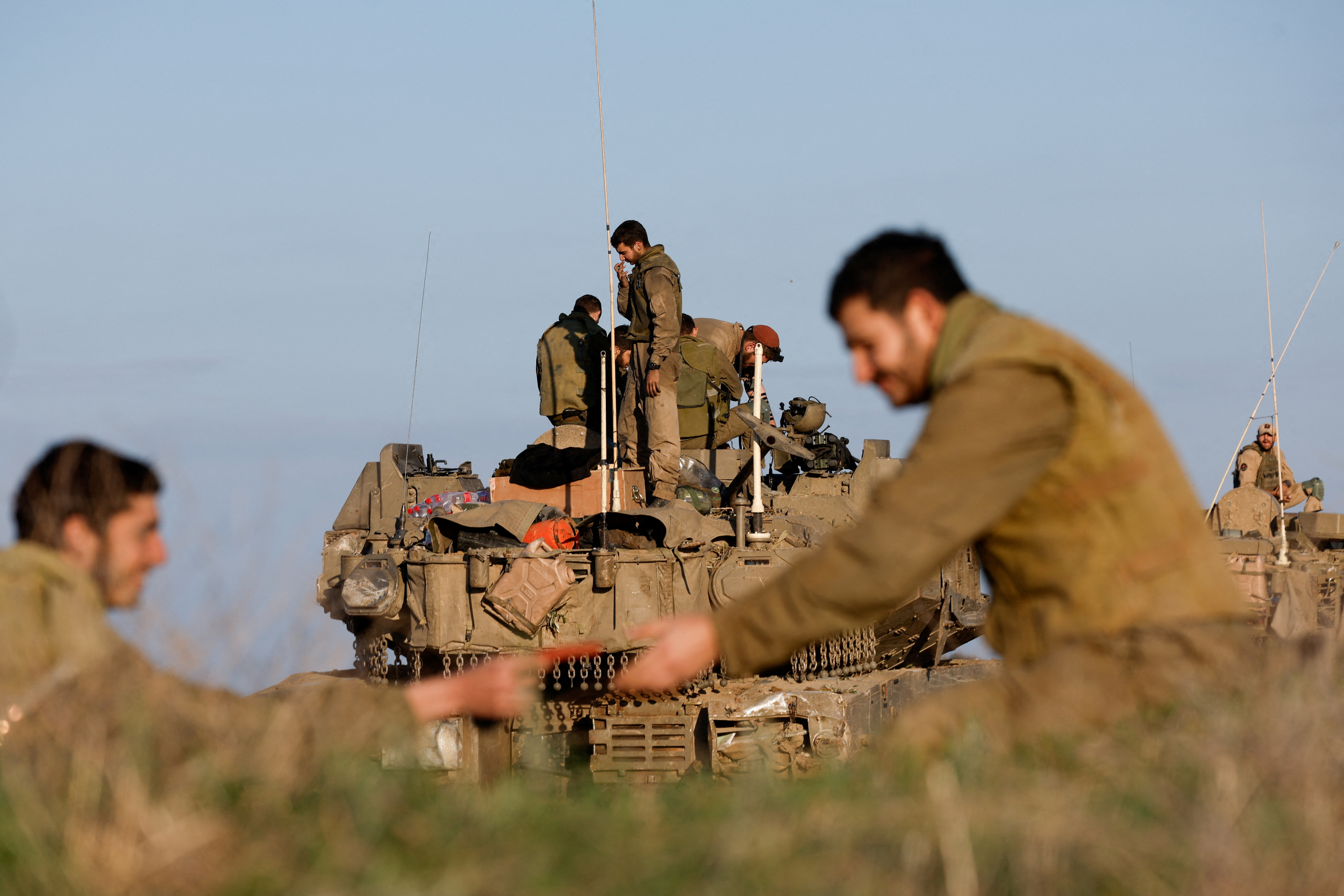 Israeli soldier stands on military vehicle on the way out of Gaza Strip, as seen from southern Israel