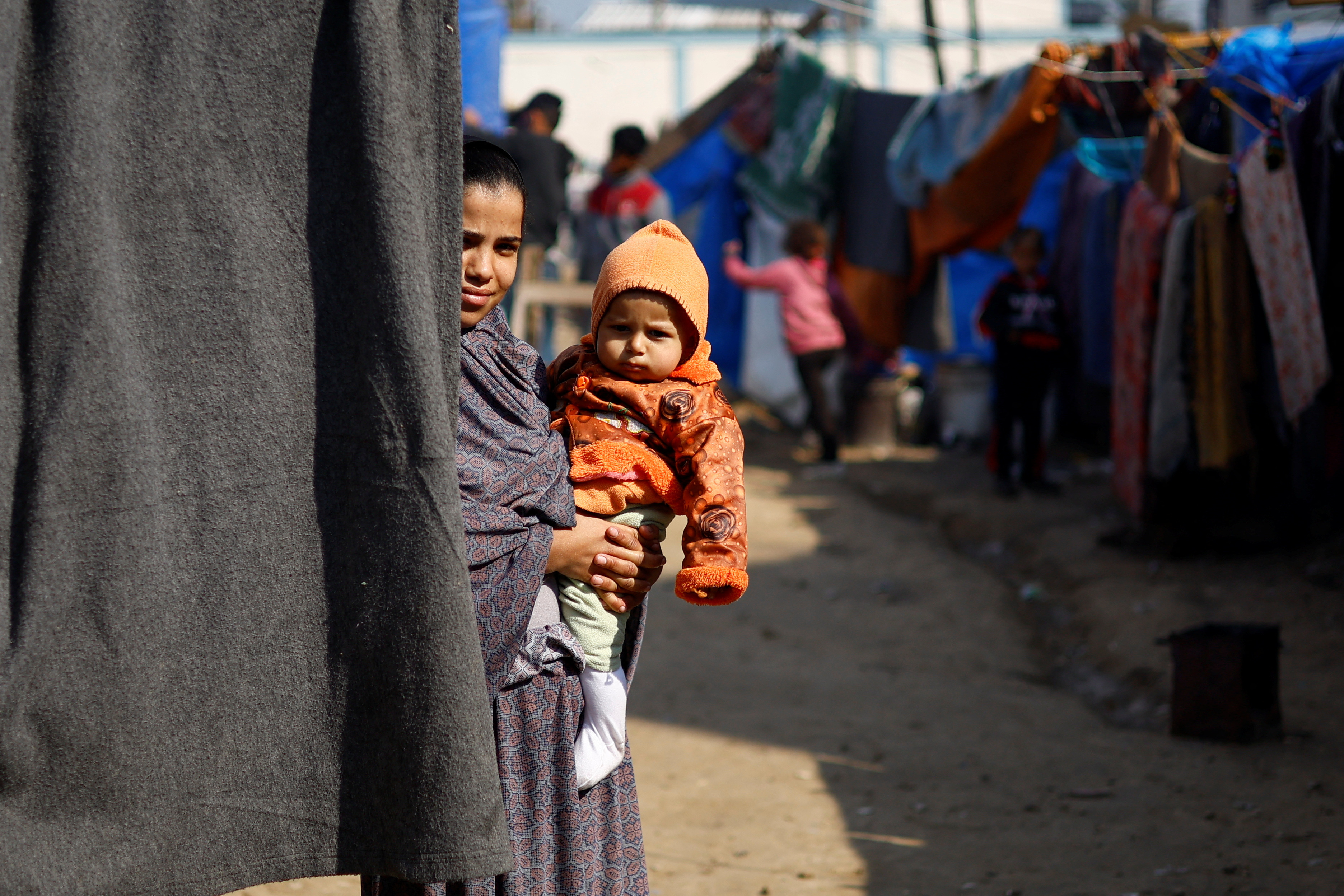 Displaced Palestinians, who fled their houses due to Israeli strikes, shelter at a tent camp in Rafah