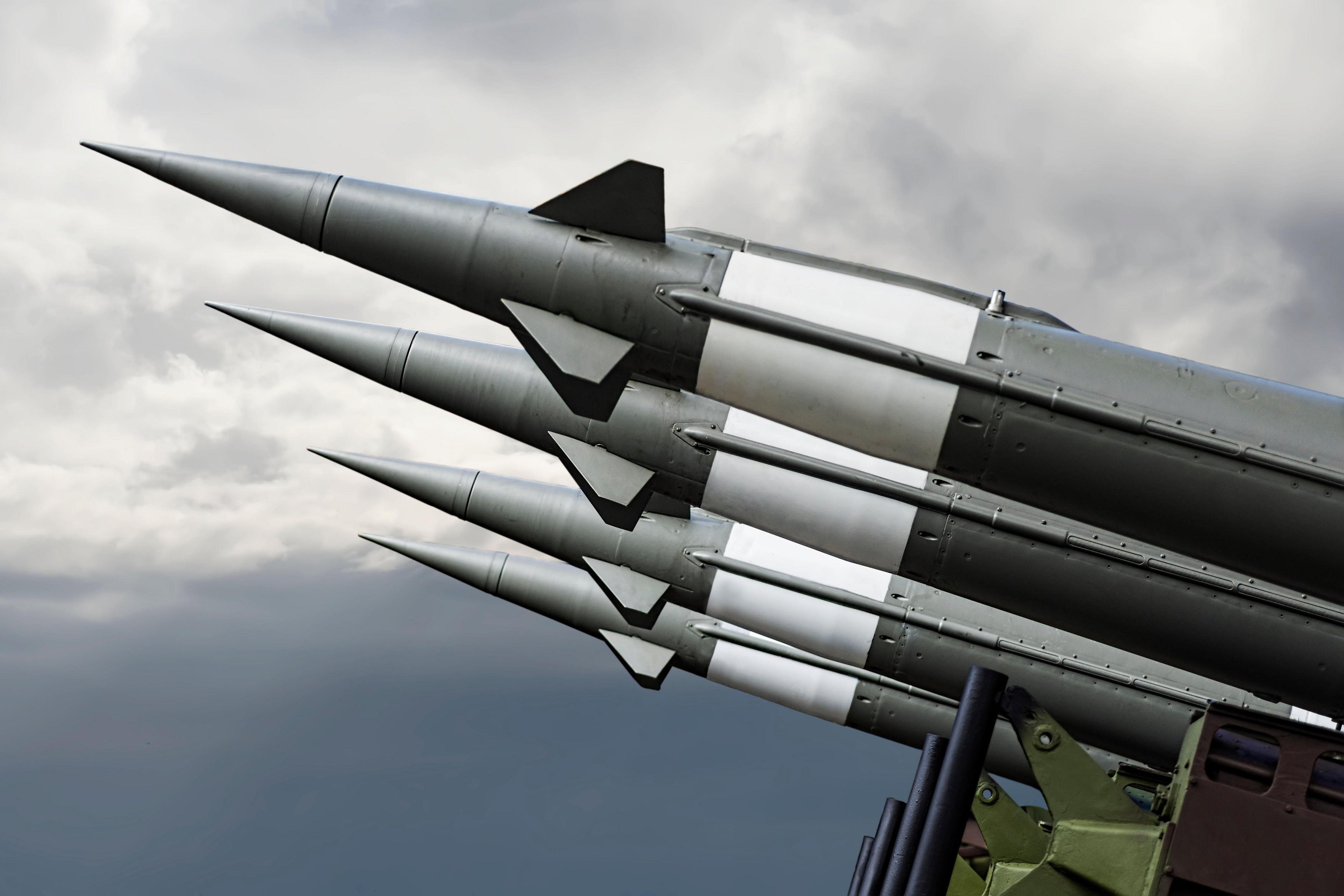 Nuclear Missiles With Warhead Aimed at Gloomy Sky. Balistic Rockets War Background.
