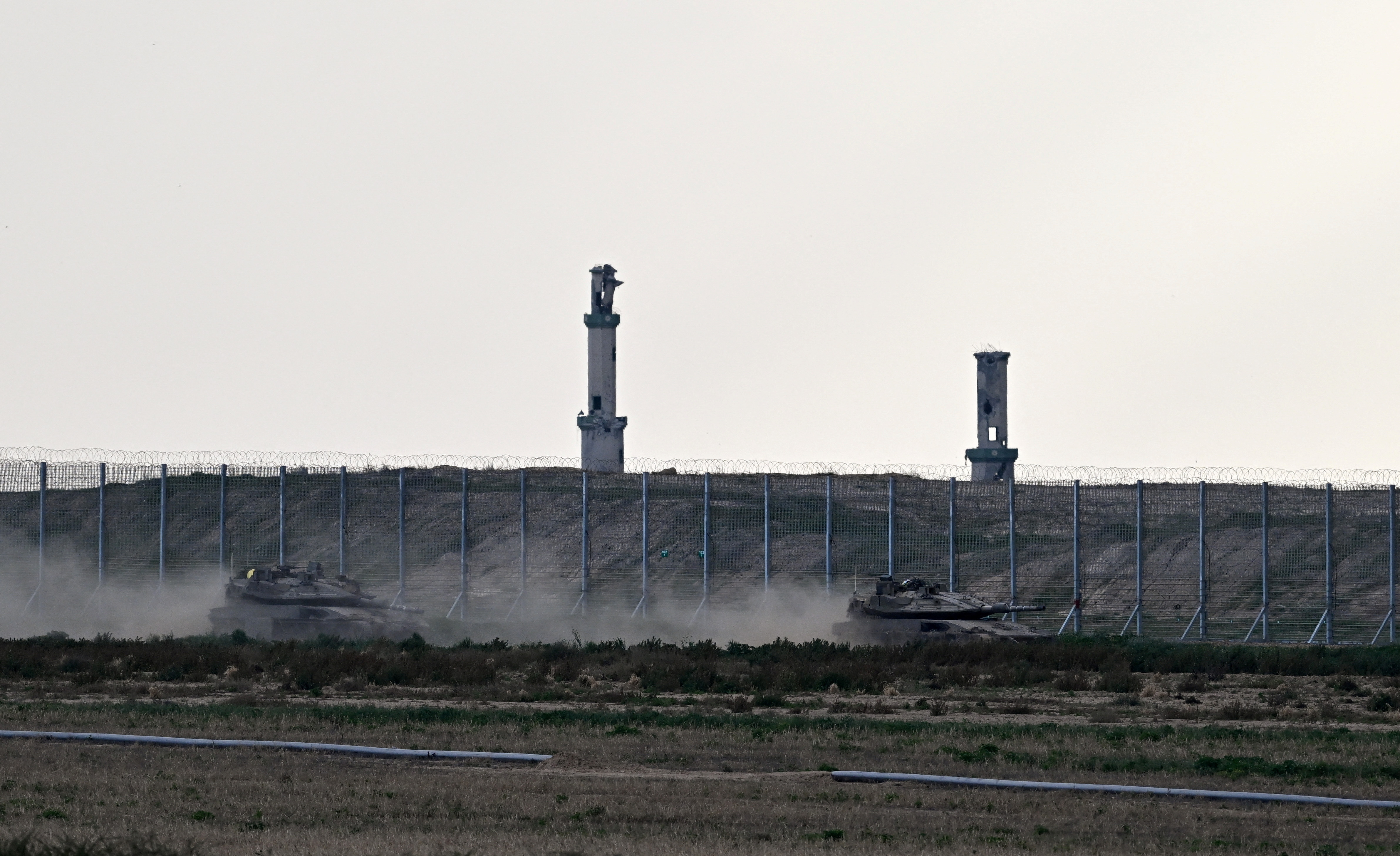 Tanks manoeuvre along the border with Gaza, as seen from Israel