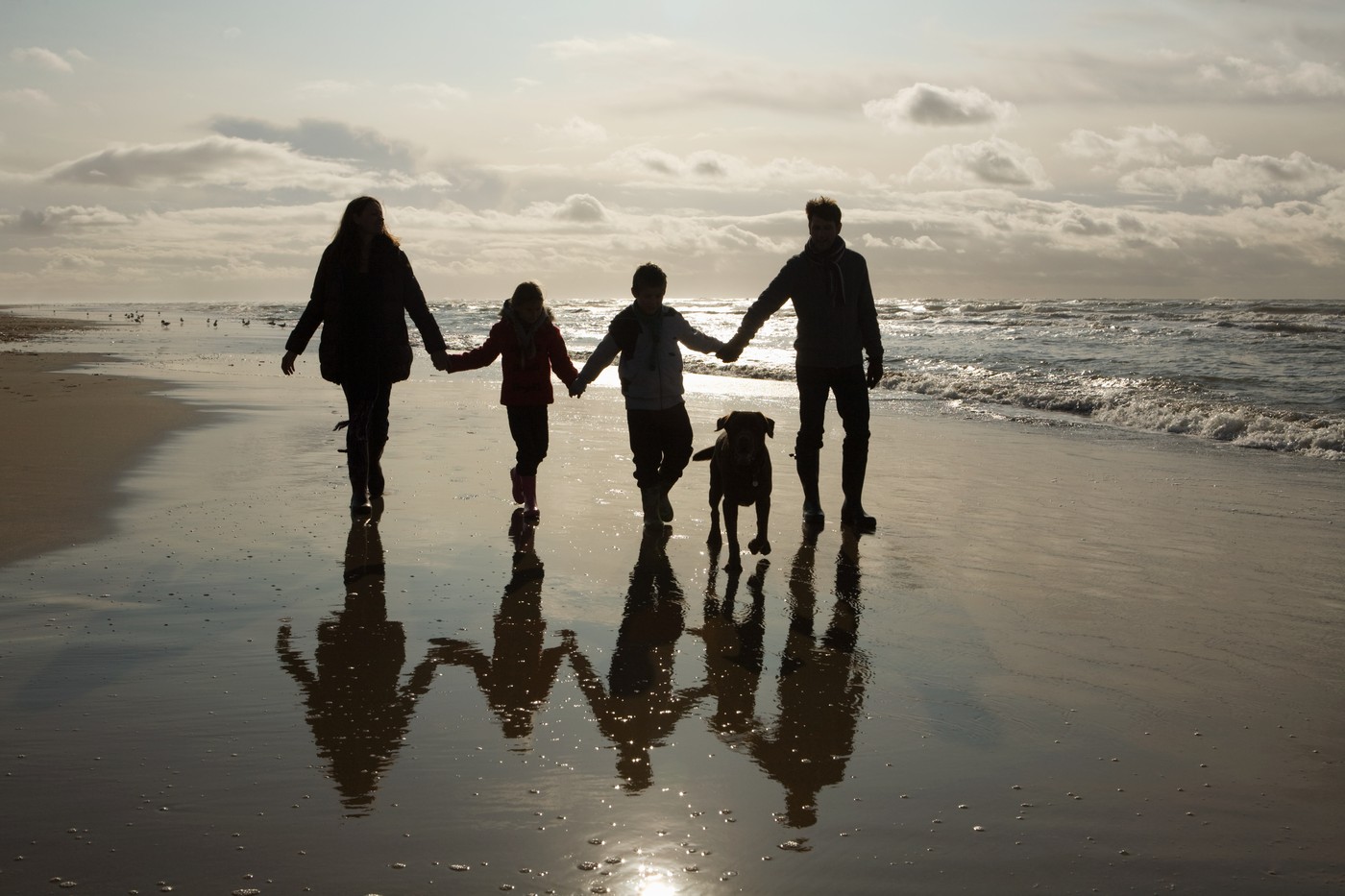 Family and dog by the sea