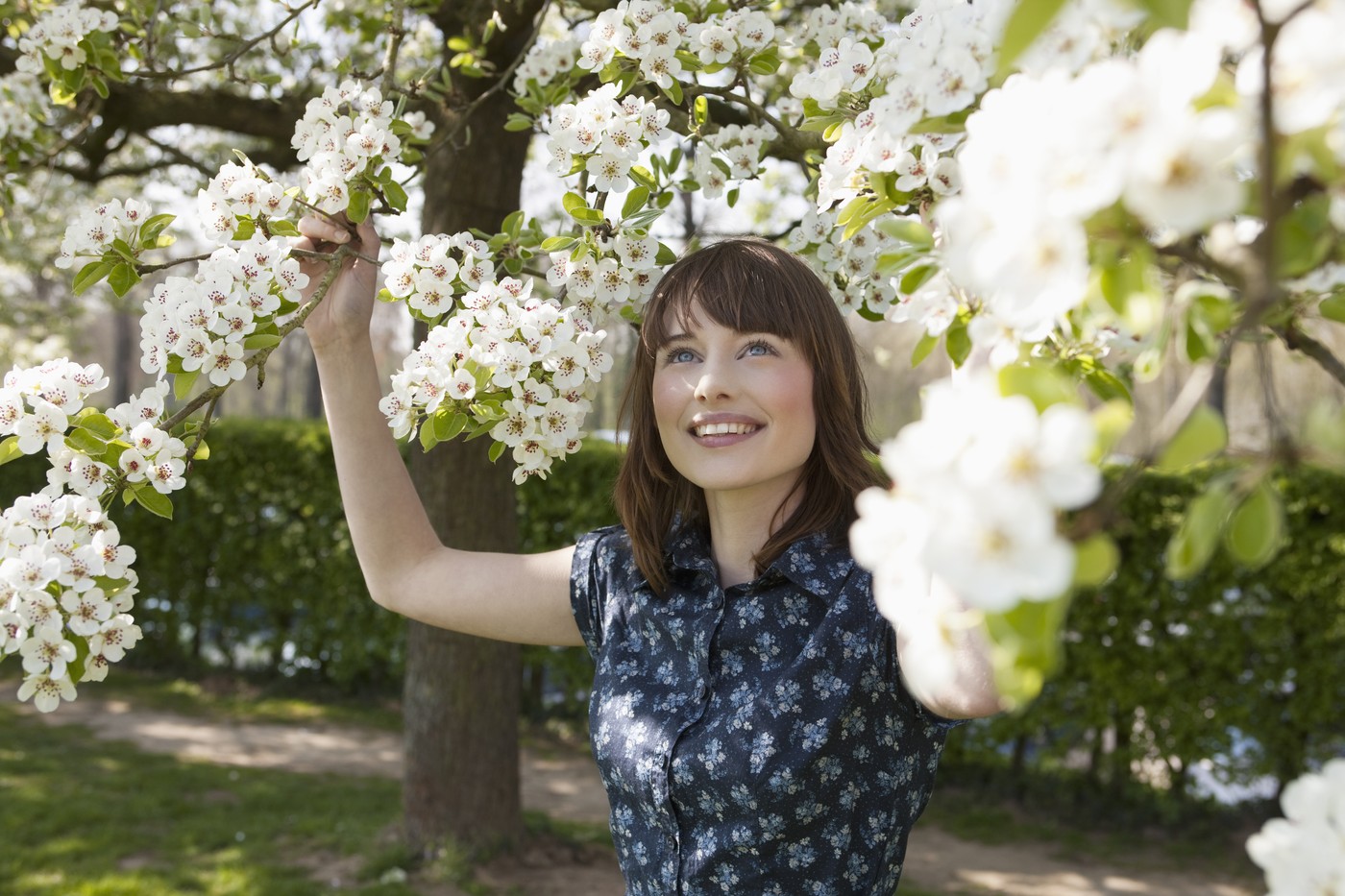 Portrait of young woman in spring orchard