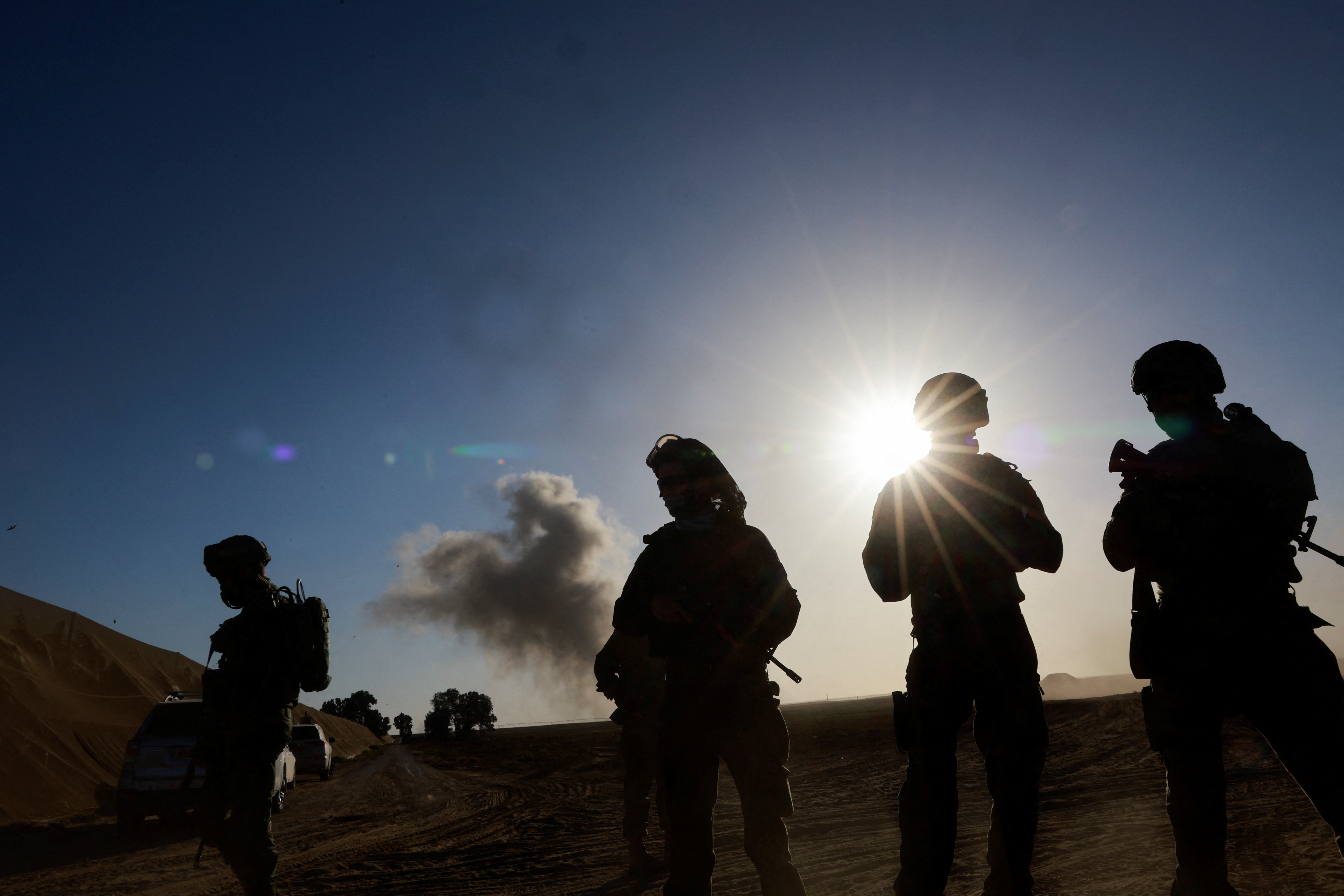 Israeli soldiers stand, near the Israel-Gaza border, in Israel