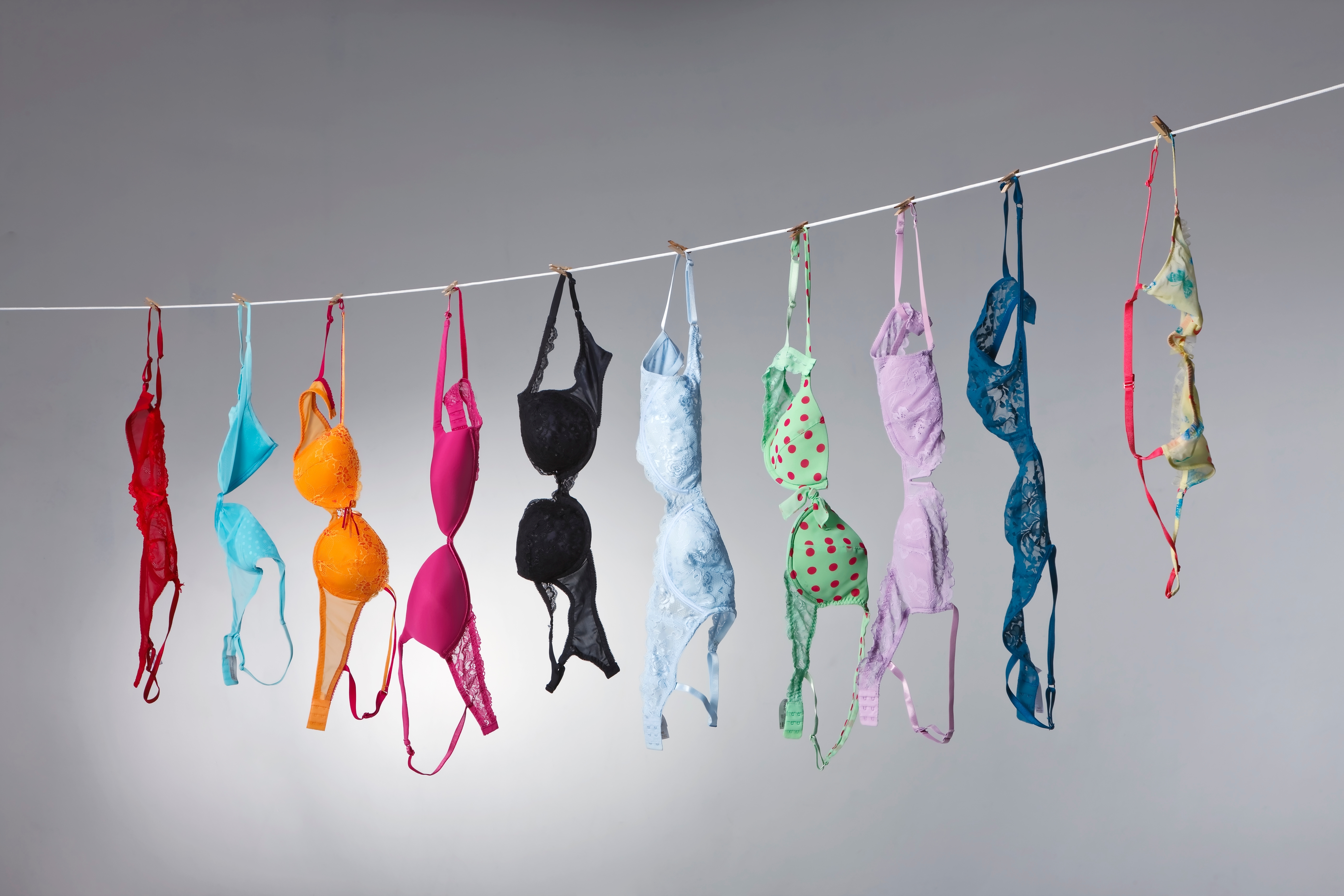 A,Group,Of,Colorful,Bras,Hang,On,A,Clothes,Line