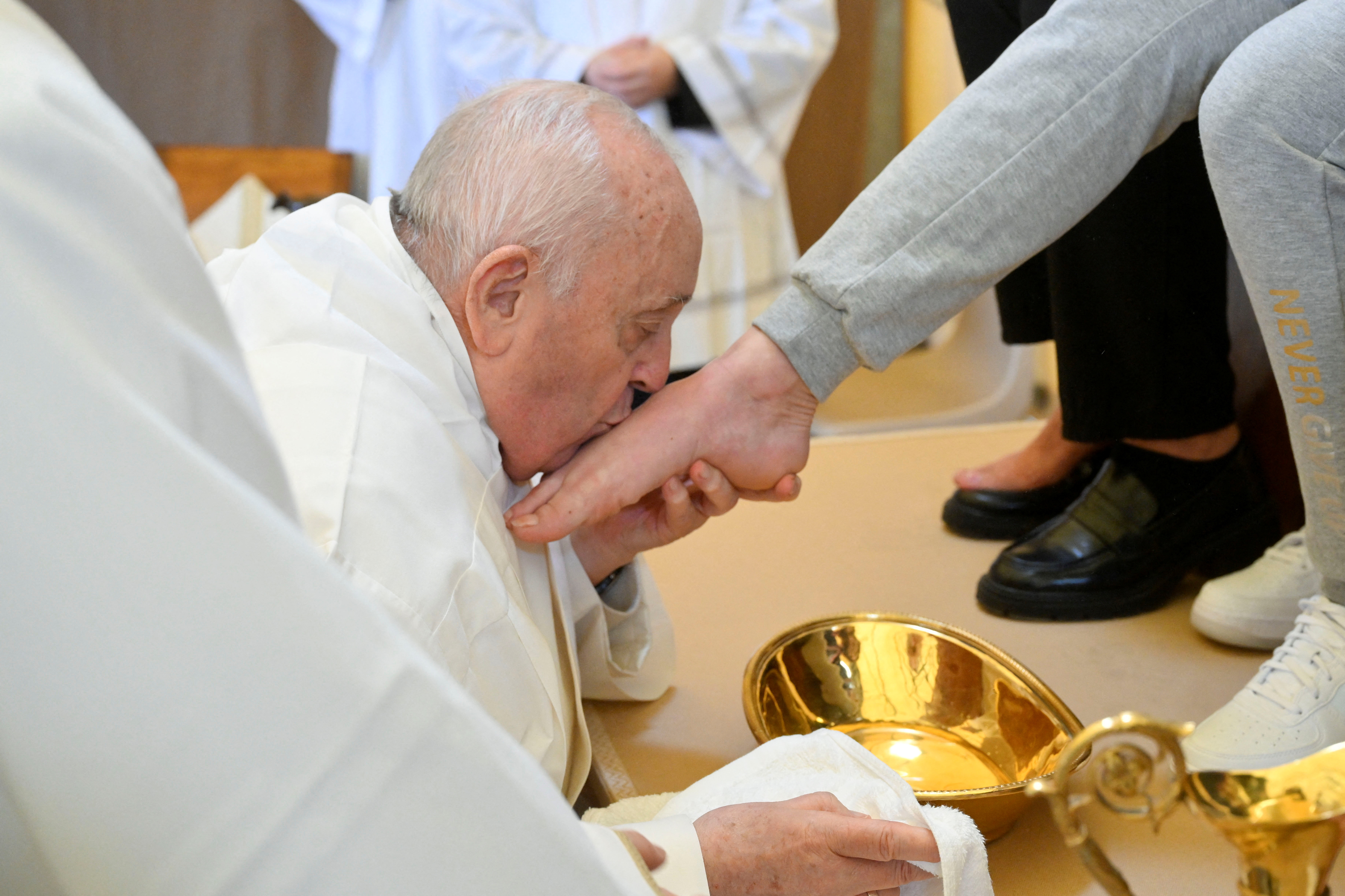 Pope Francis kisses the feet of an inmate of the female section of Rebibbia Prison during a Holy Thursday ritual, in Rome