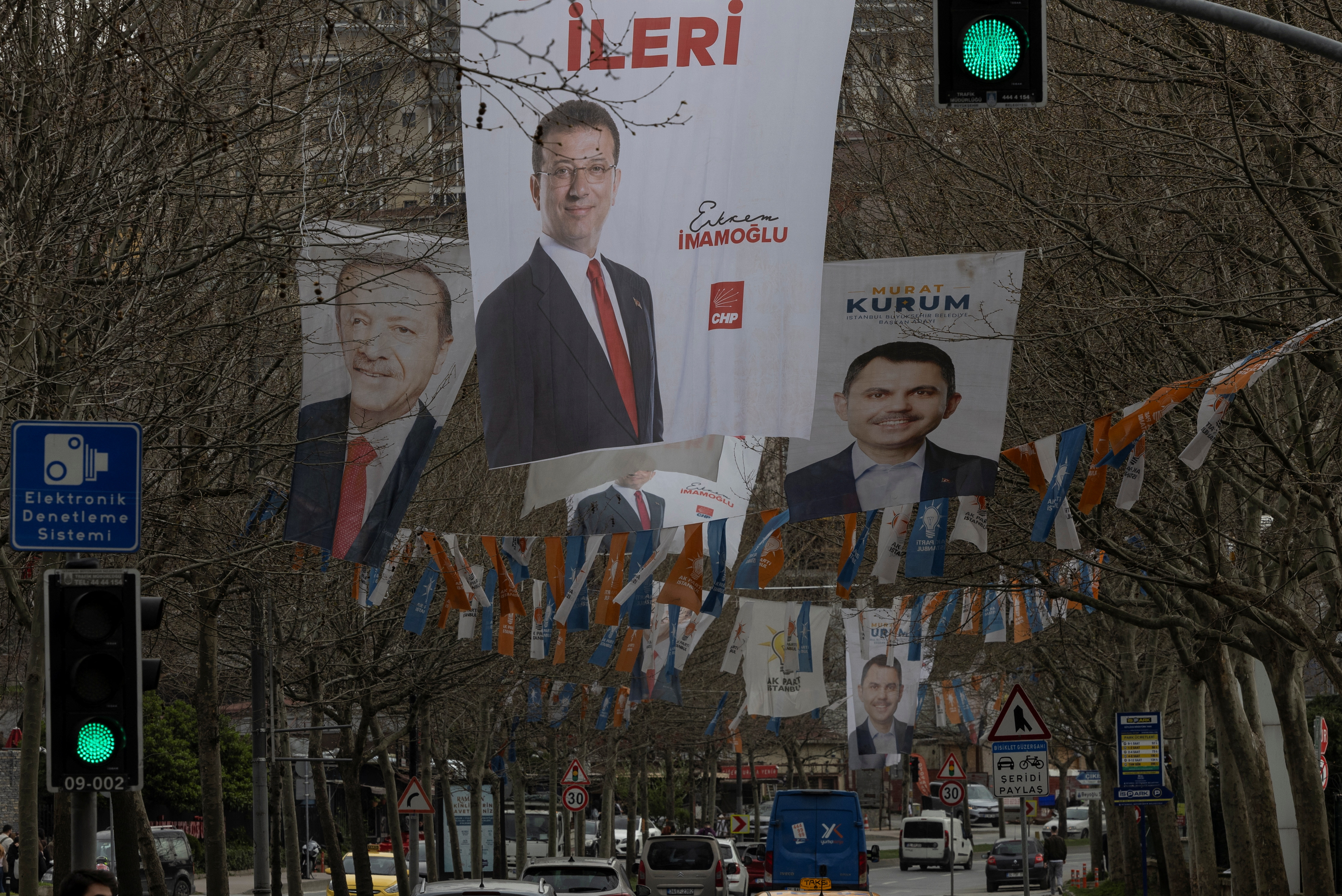 Election banners of Istanbul's mayor Ekrem Imamoglu, President Tayyip Erdogan and Murat Kurum hang along a street ahead of the local elections in Istanbul