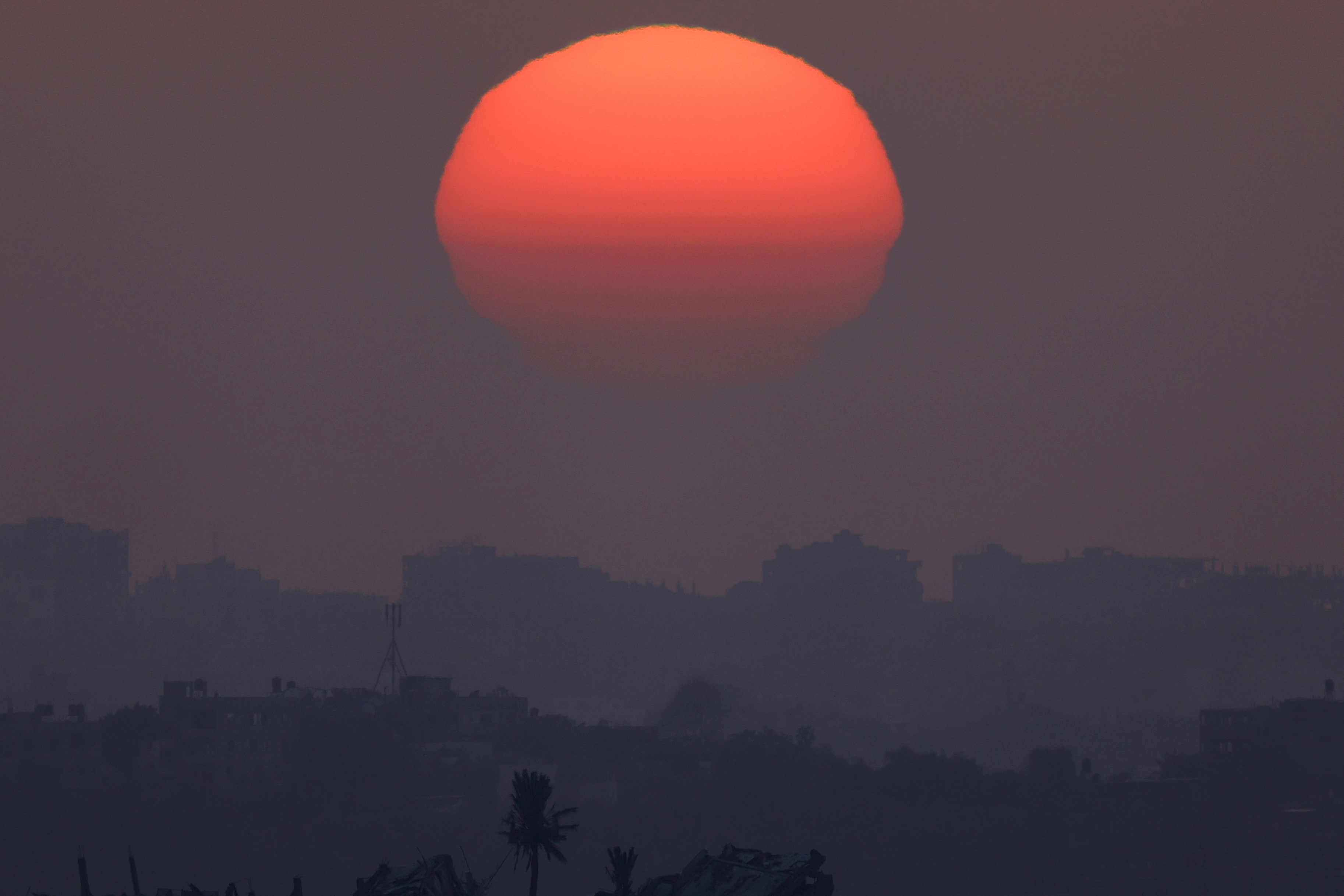 The sun sets over Gaza, as seen from southern Israel