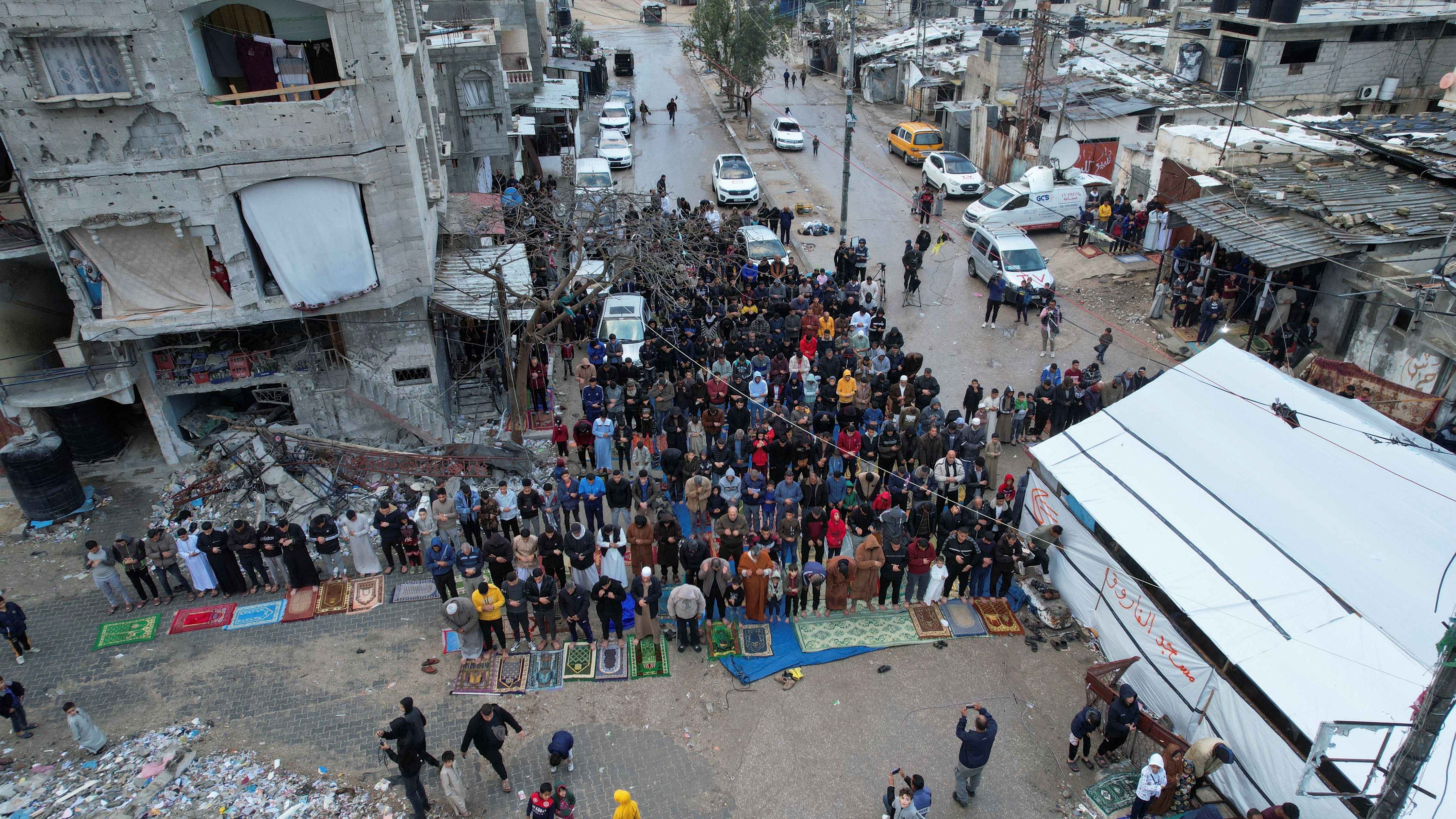 Palestinians hold Eid al-Fitr prayers by the ruins of al-Farouk mosque in Rafah