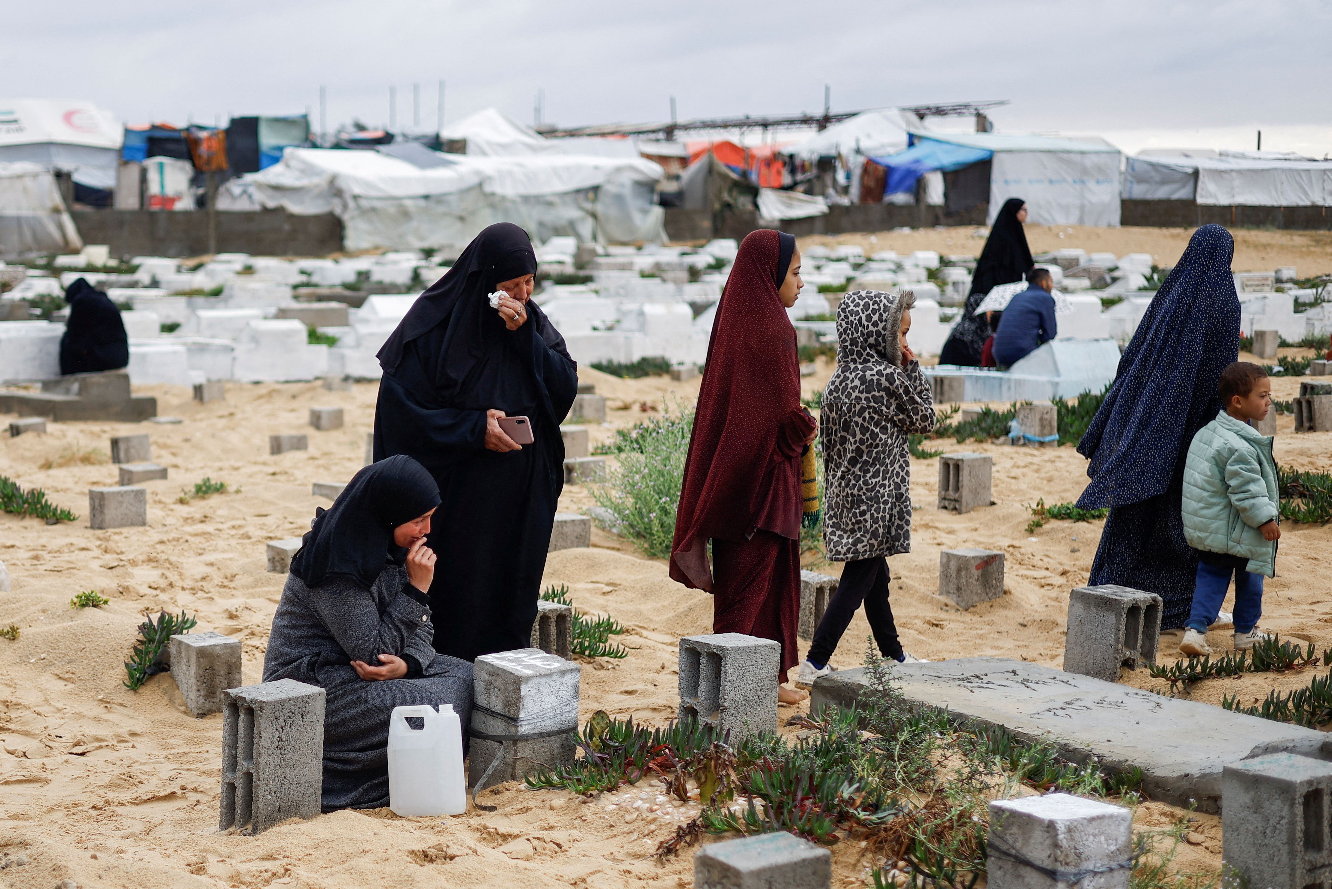 Palestinians hold Eid al-Fitr prayers by the ruins of al-Farouk mosque, in Rafah