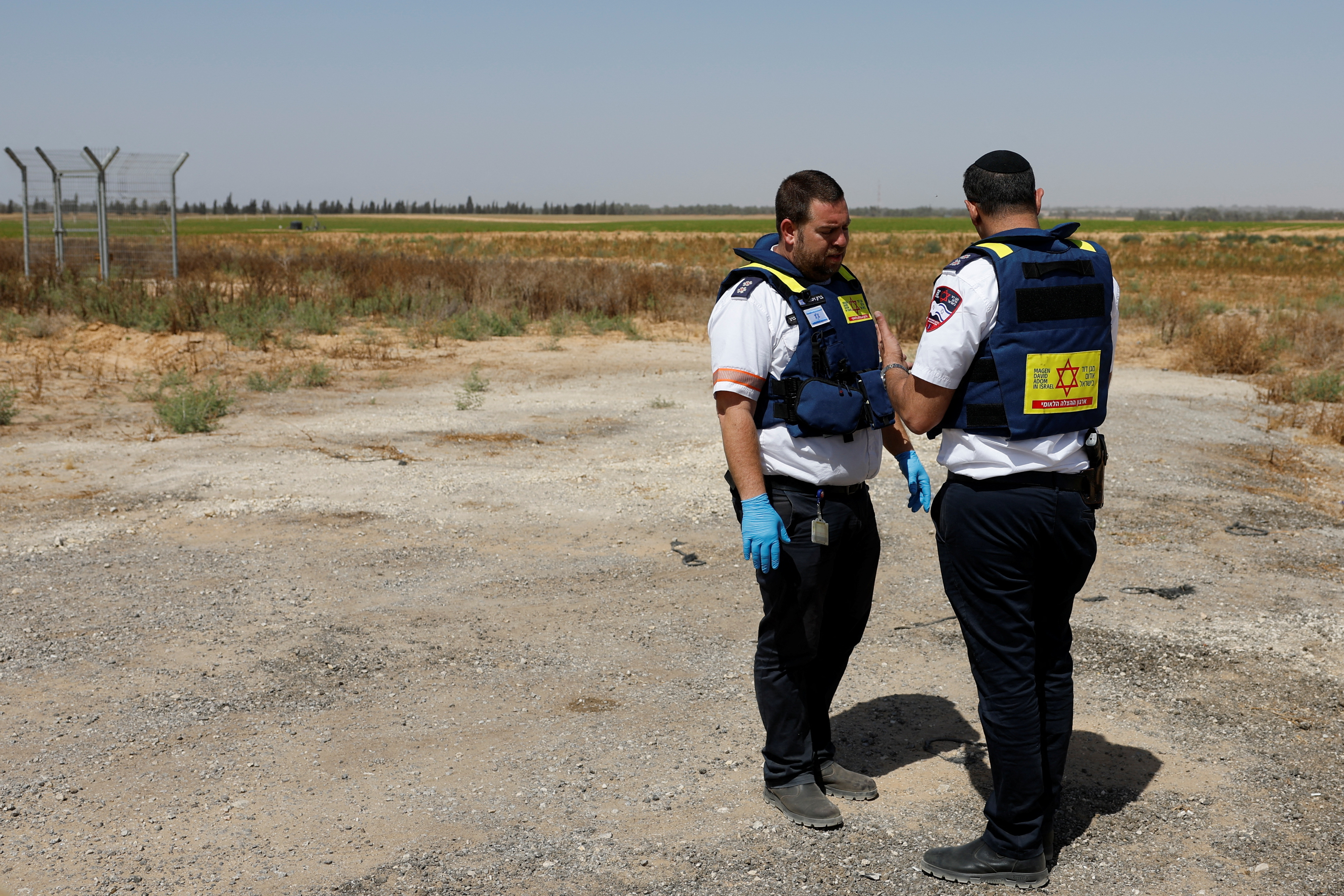 Israeli medics talk after Palestinian Islamist group Hamas claimed responsibility for an attack on Kerem Shalom crossing