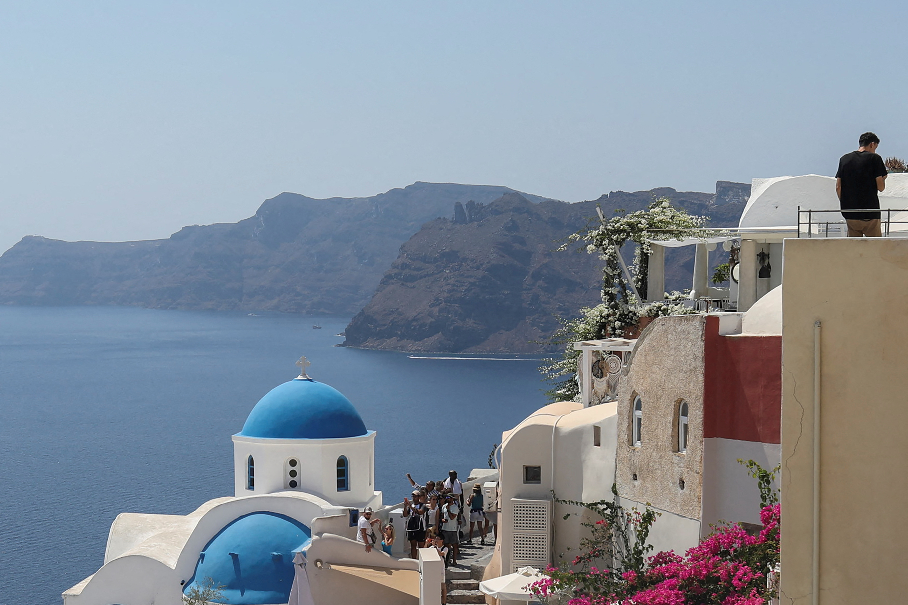 FILE PHOTO: Tourists visit Oia, on the island of Santorini