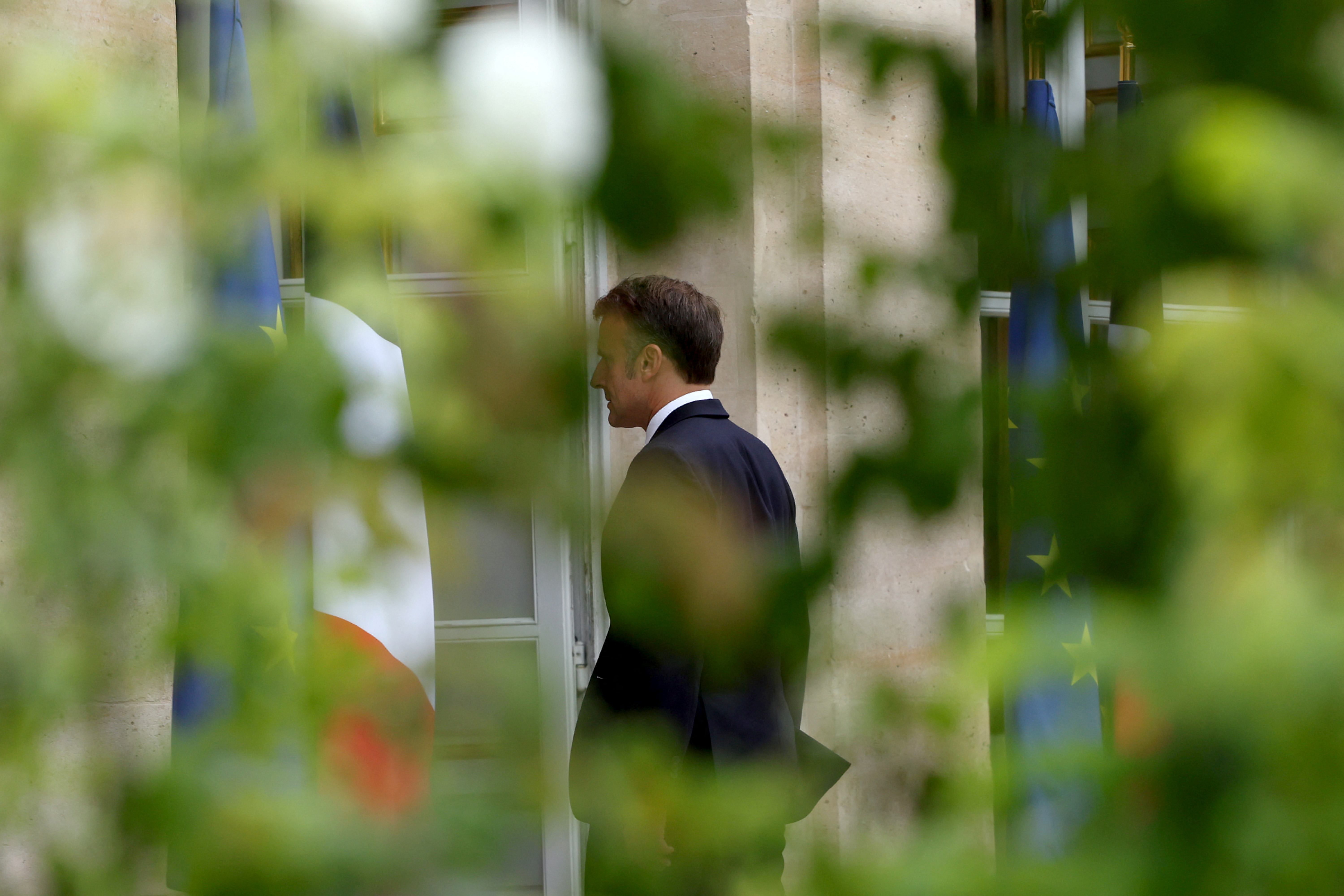 French President Emmanuel Macron reviews troops that will take part in the Bastille Day parade, in Paris