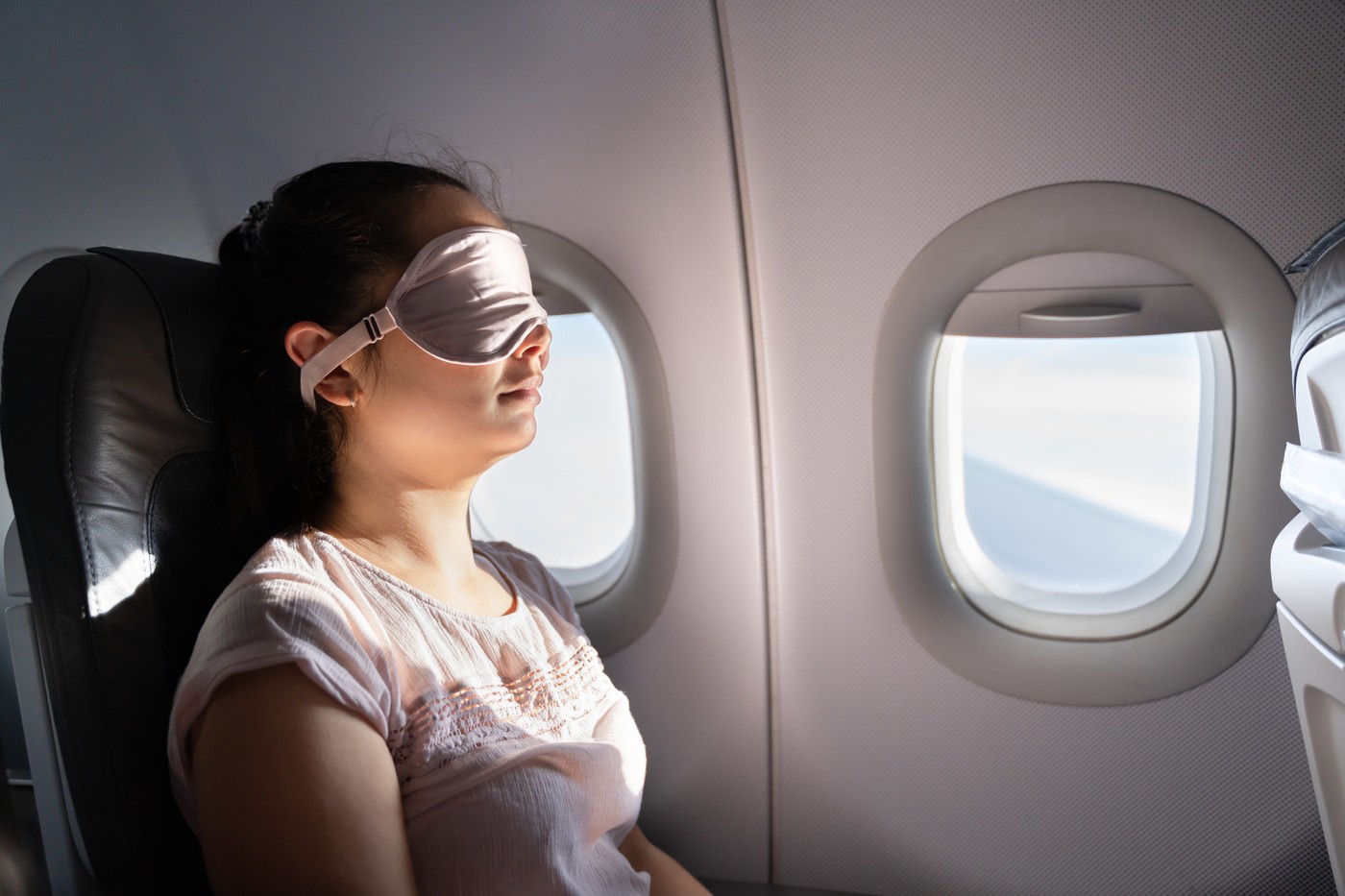 Woman With Sleep Mask On Airplane