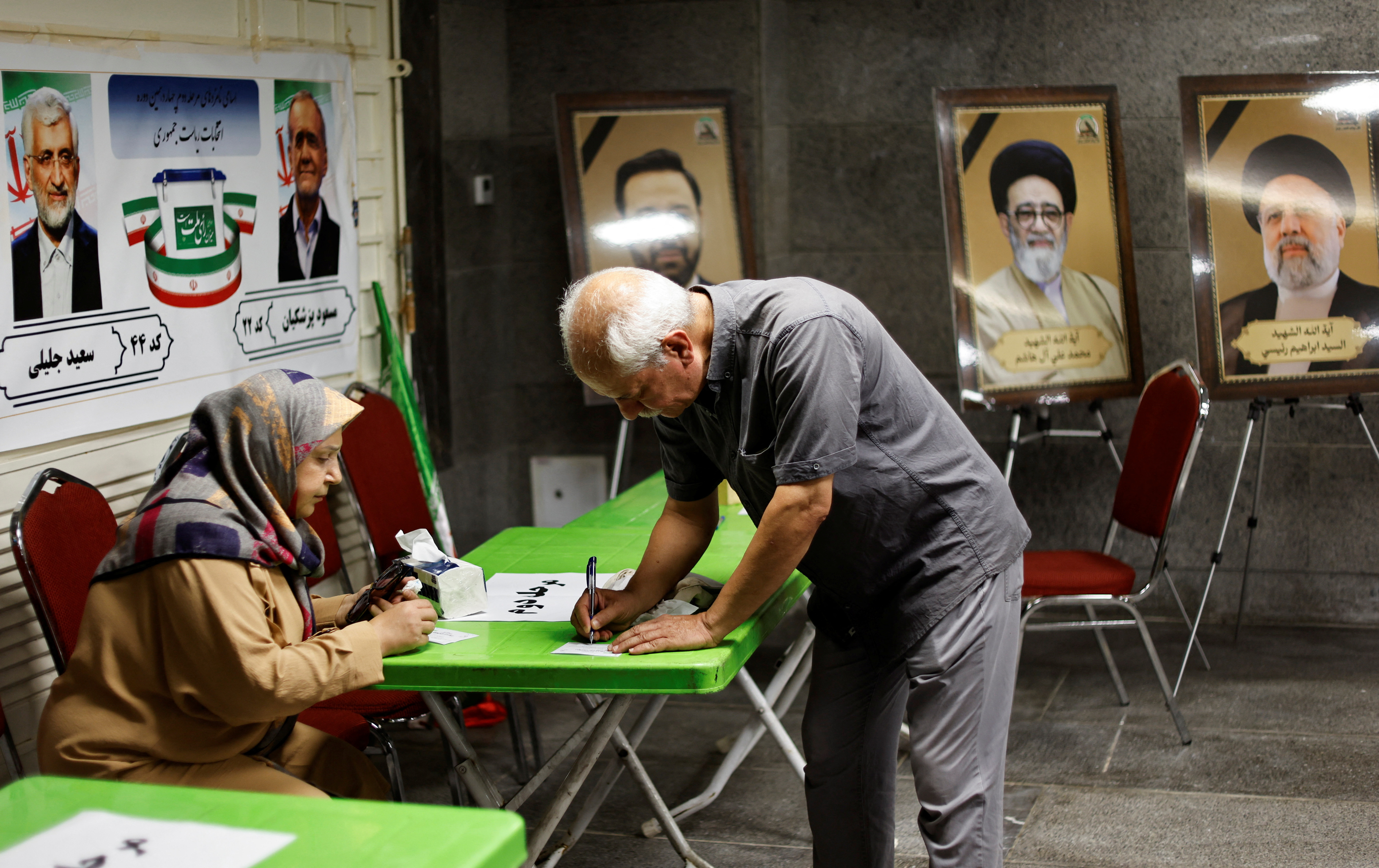 An Iranian voter participates in the run-off presidential election between Masoud Pezeshkian and Saeed Jalili,at the Iranian embassy, in Baghdad