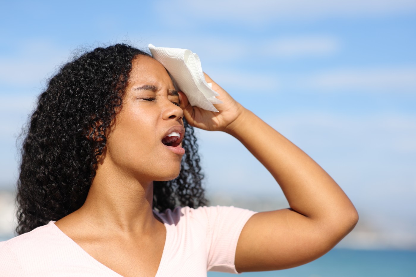Overwhelmed black woman sweating a hot day