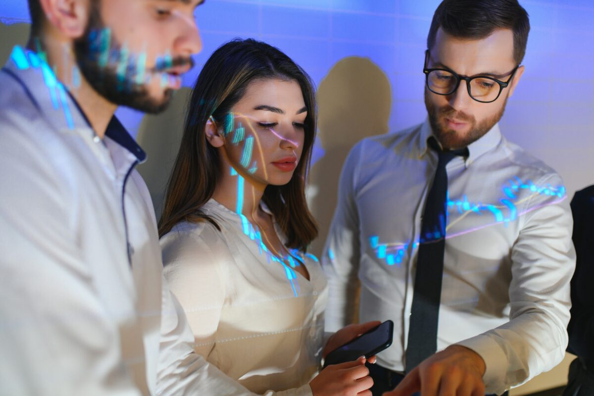 Group of business people working. Technical price graph and indicator, red and blue candlestick chart and stock trading computer screen background. Traders analyzing data