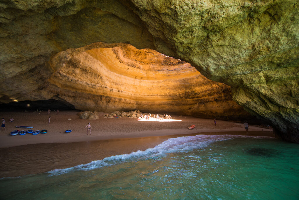 1721977602-benagil-cave-boat-tour-inside-algar-de-benagil-cave-listed-world-s-top-10-best-caves-algarve-coast-near-lagoa-portugal-tourists-visit-popular-landmark-1024x683.jpg