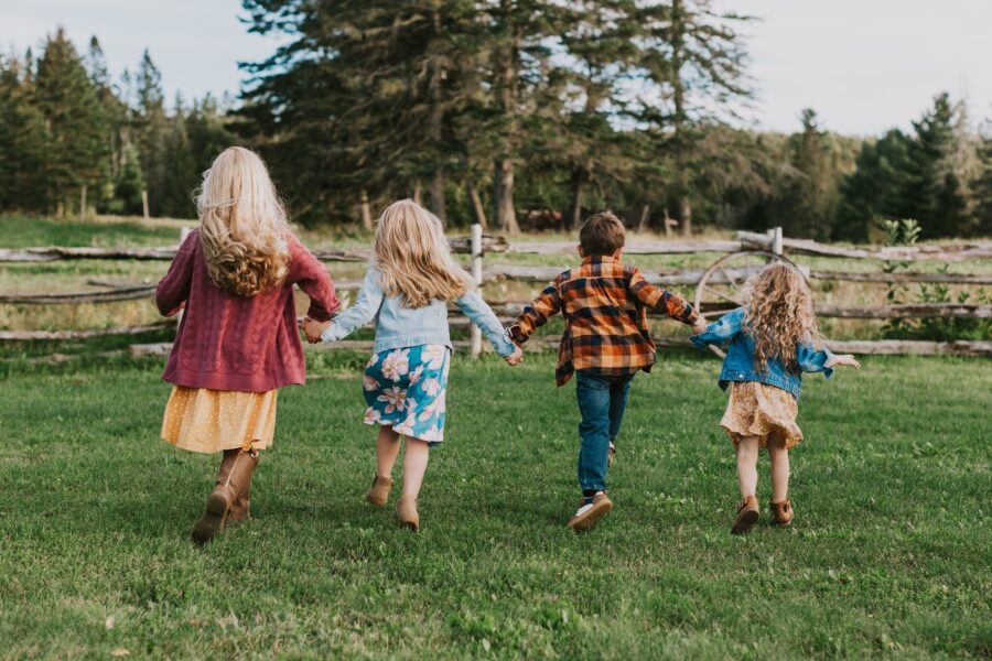 Back view of four siblings in the Doak House area, New Brunswick