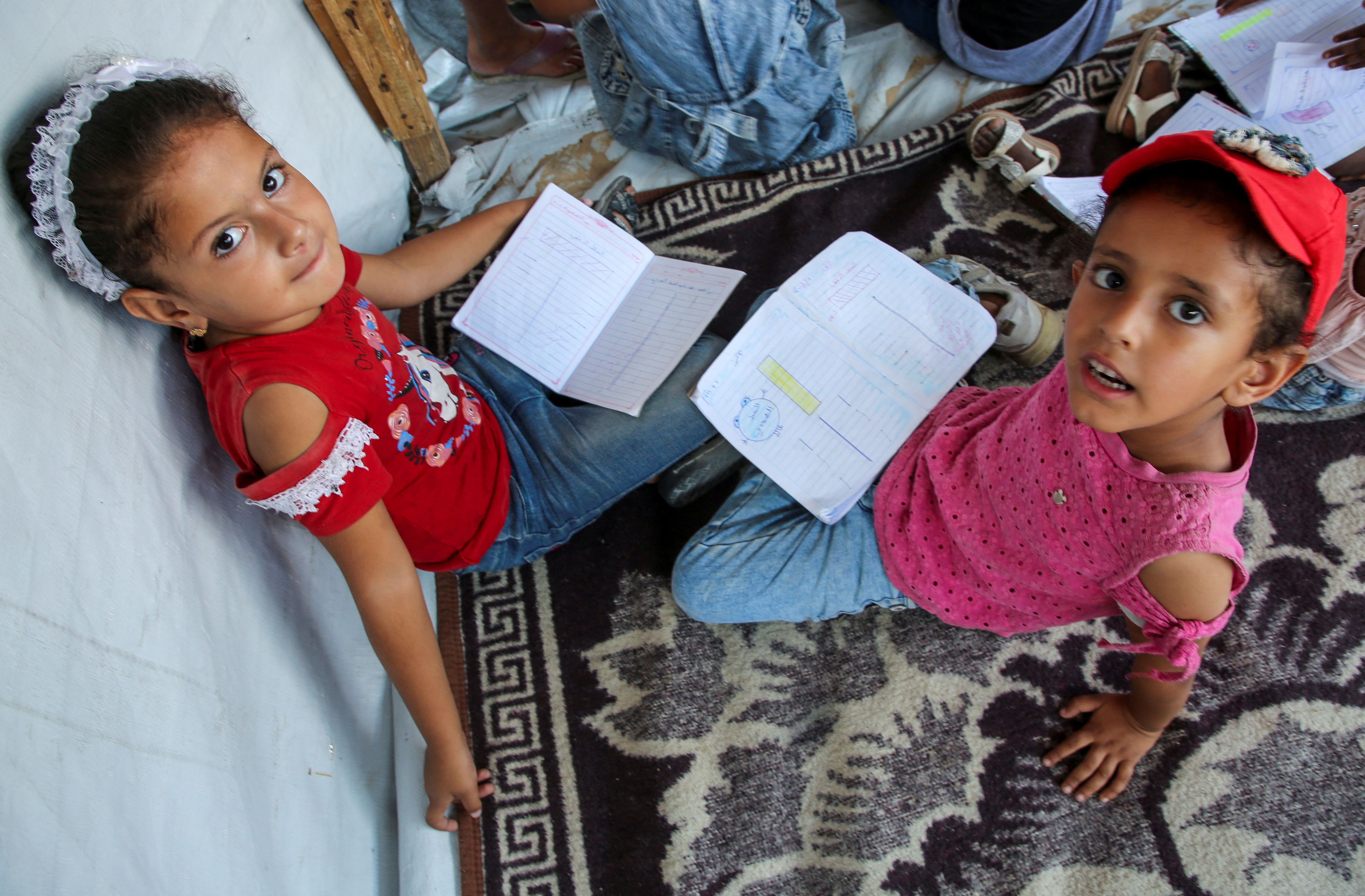 Gaza teacher welcomes students in a classroom tent set up on the rubble of her house