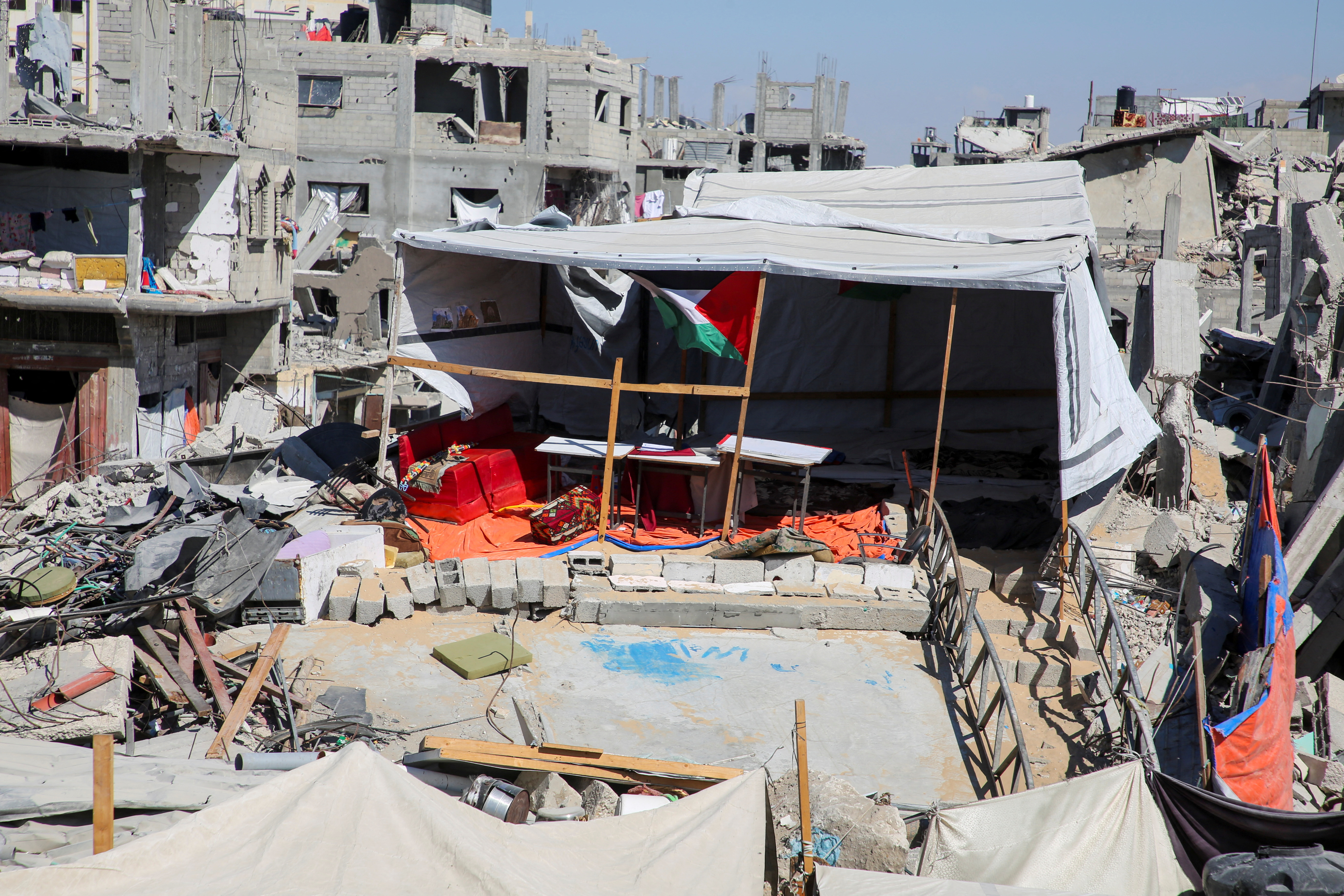Gaza teacher welcomes students in a classroom tent set up on the rubble of her house