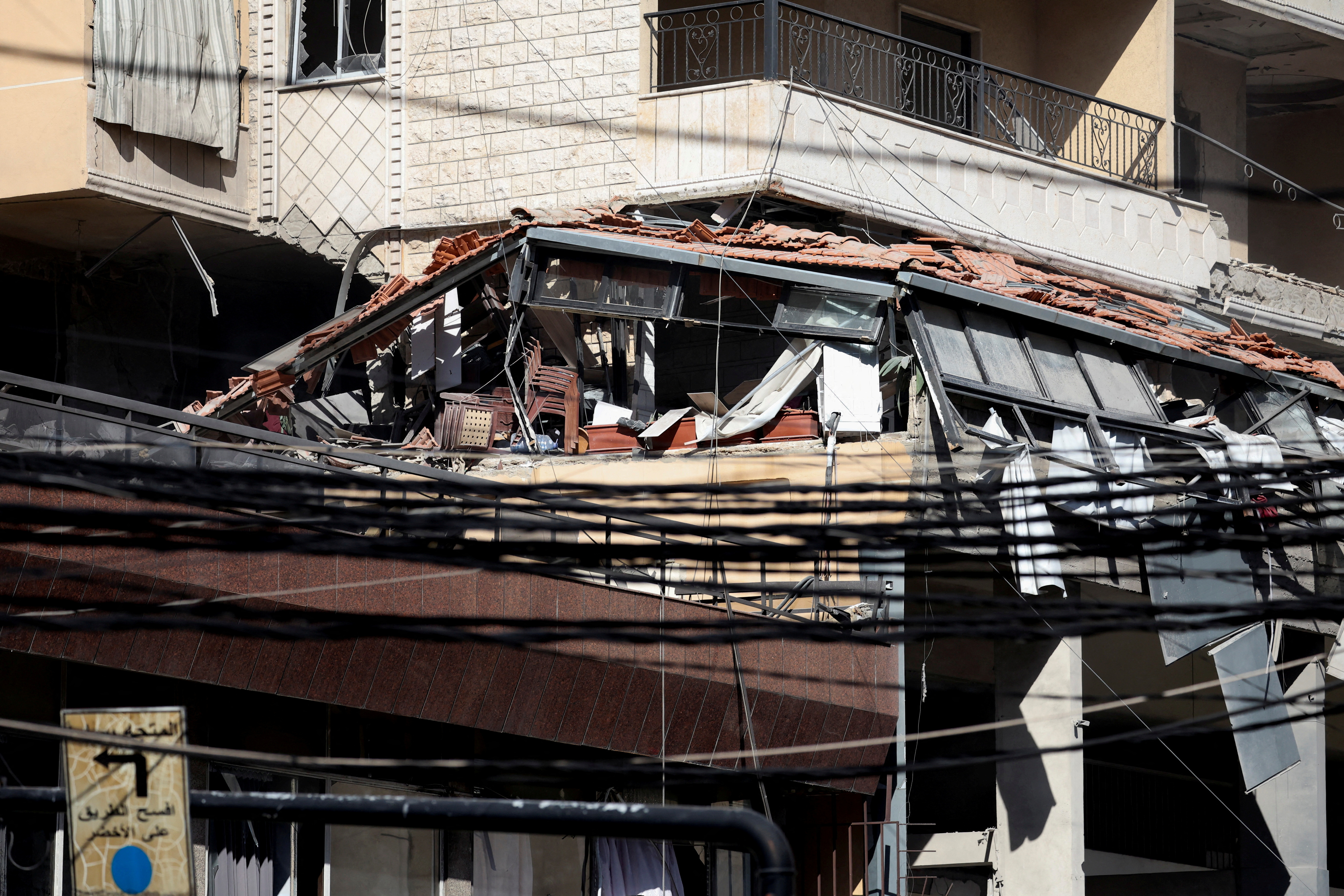 A view shows a damaged building at the site of an Israeli strike in Beirut's southern suburbs
