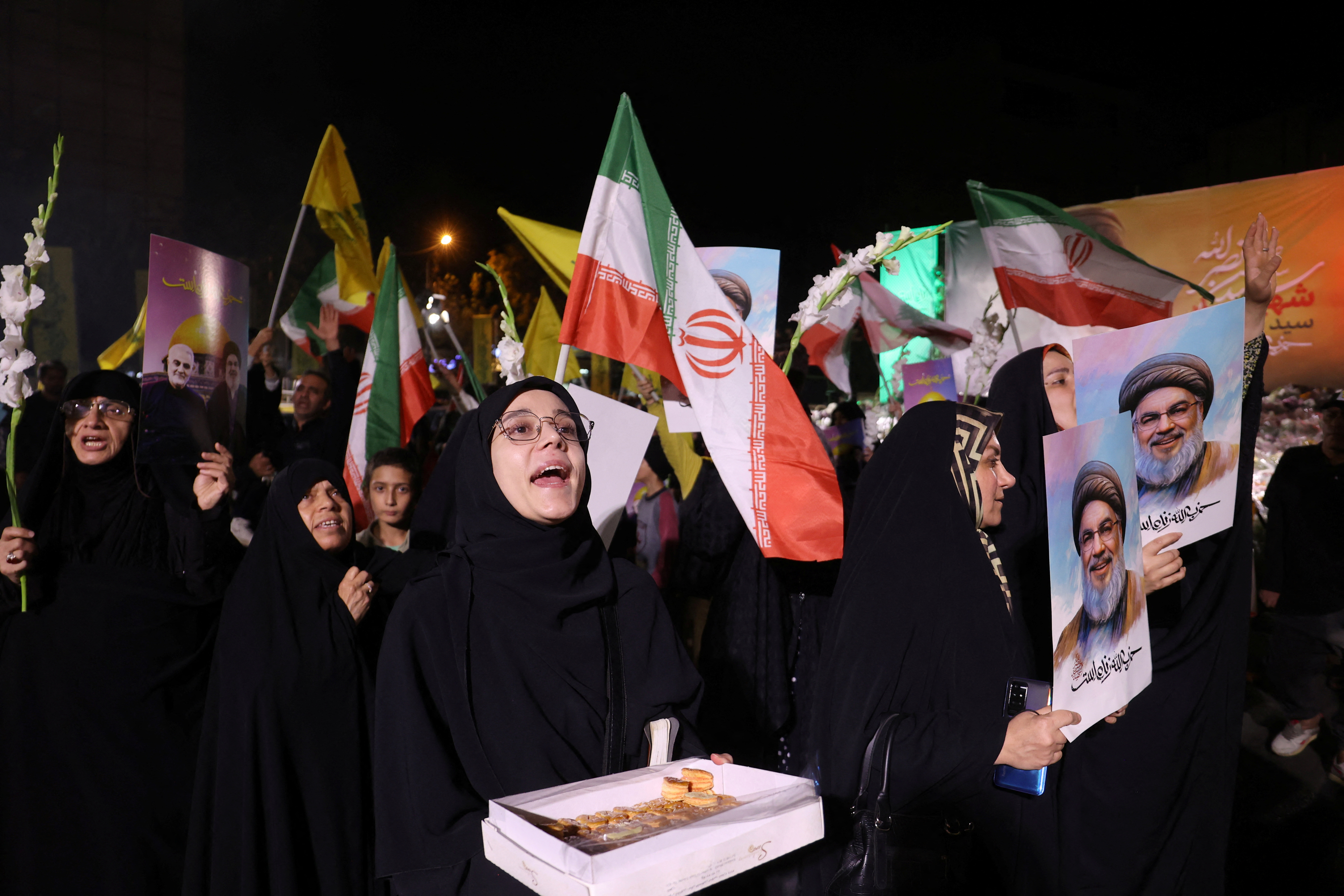 Iranians celebrate on a street, after the IRGC attack on Israel, in Tehran
