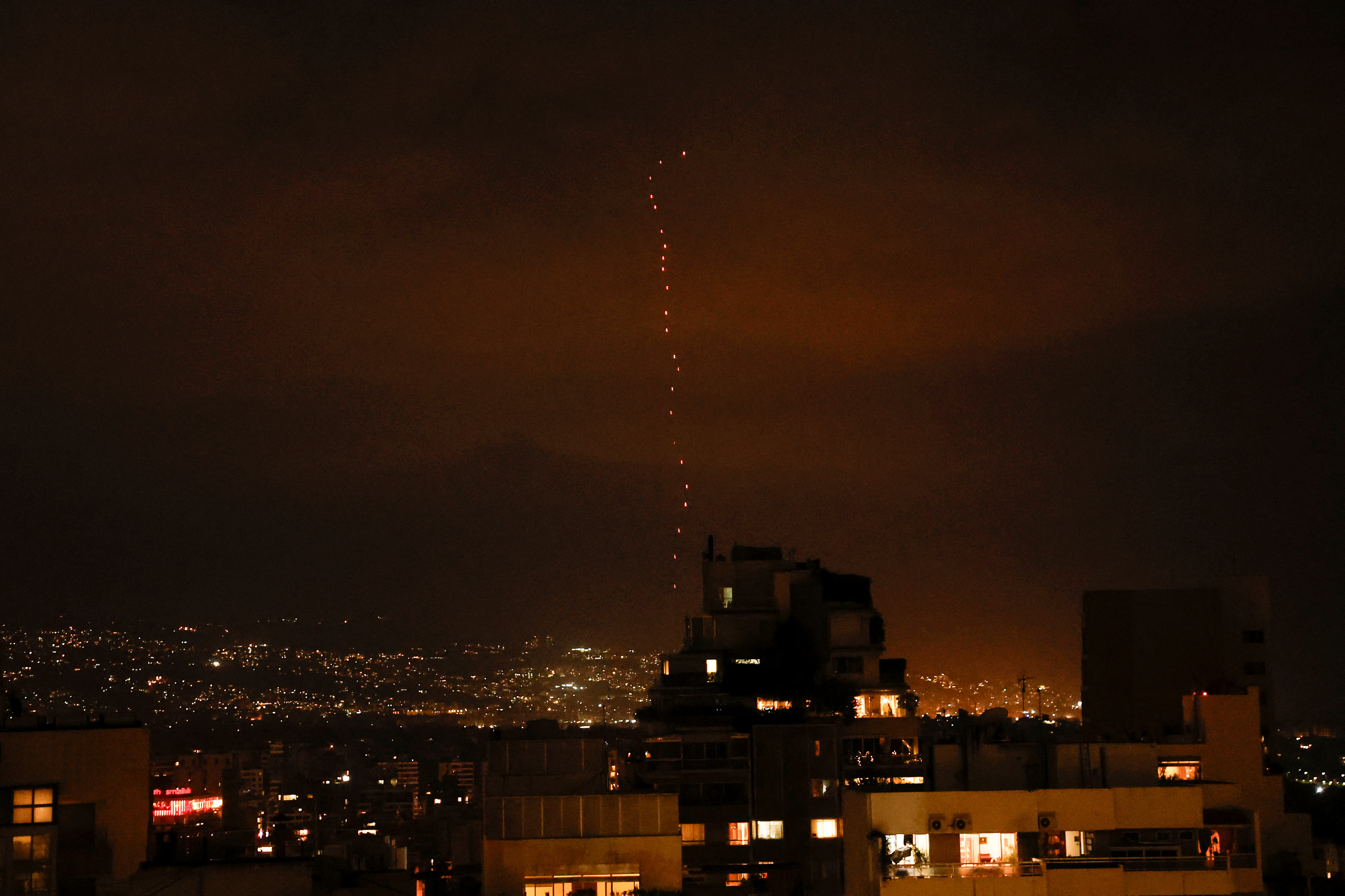 Tracers from firearms fired  into the air in celebration for Iran's missiles barrage on Israel