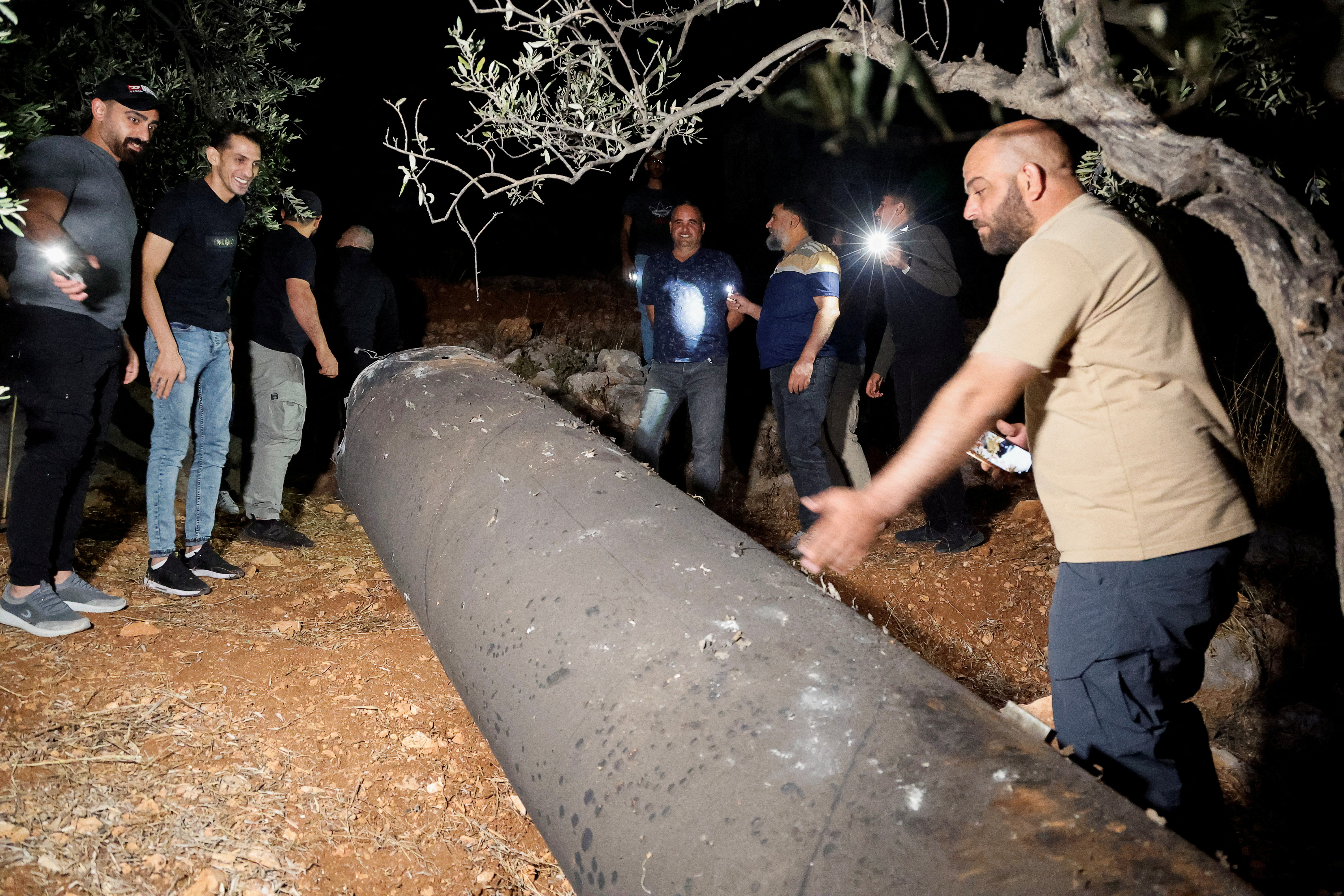 Palestinians investigate a projectile, after Iran fired a salvo of ballistic missiles, in Tubas