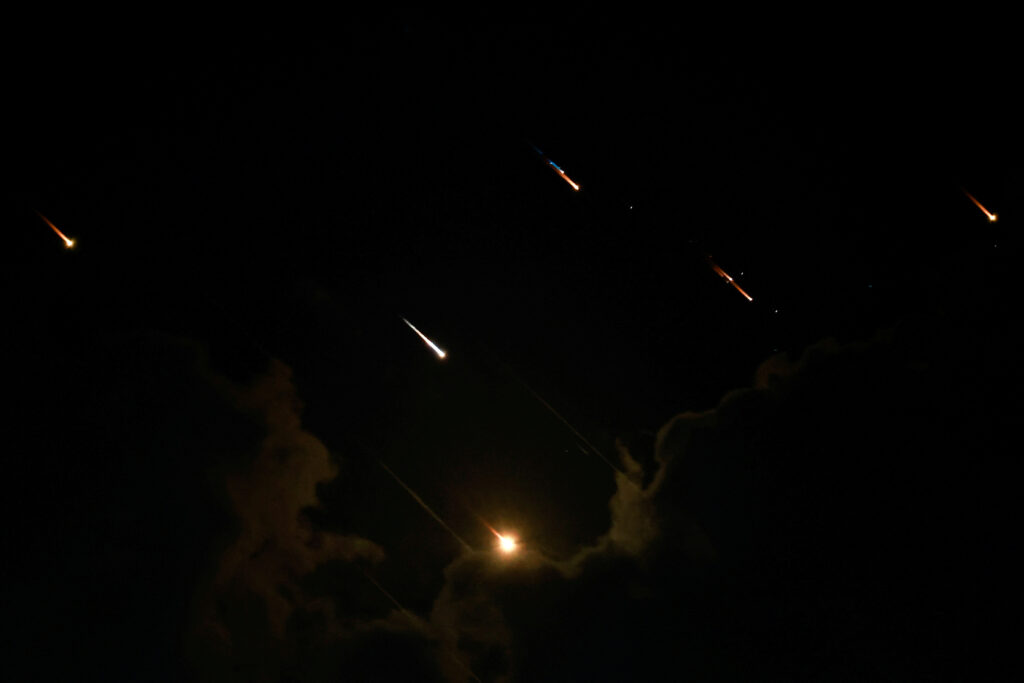 Rockets fly in the sky, amid cross-border hostilities between Hezbollah and Israel, as seen from Tel Aviv