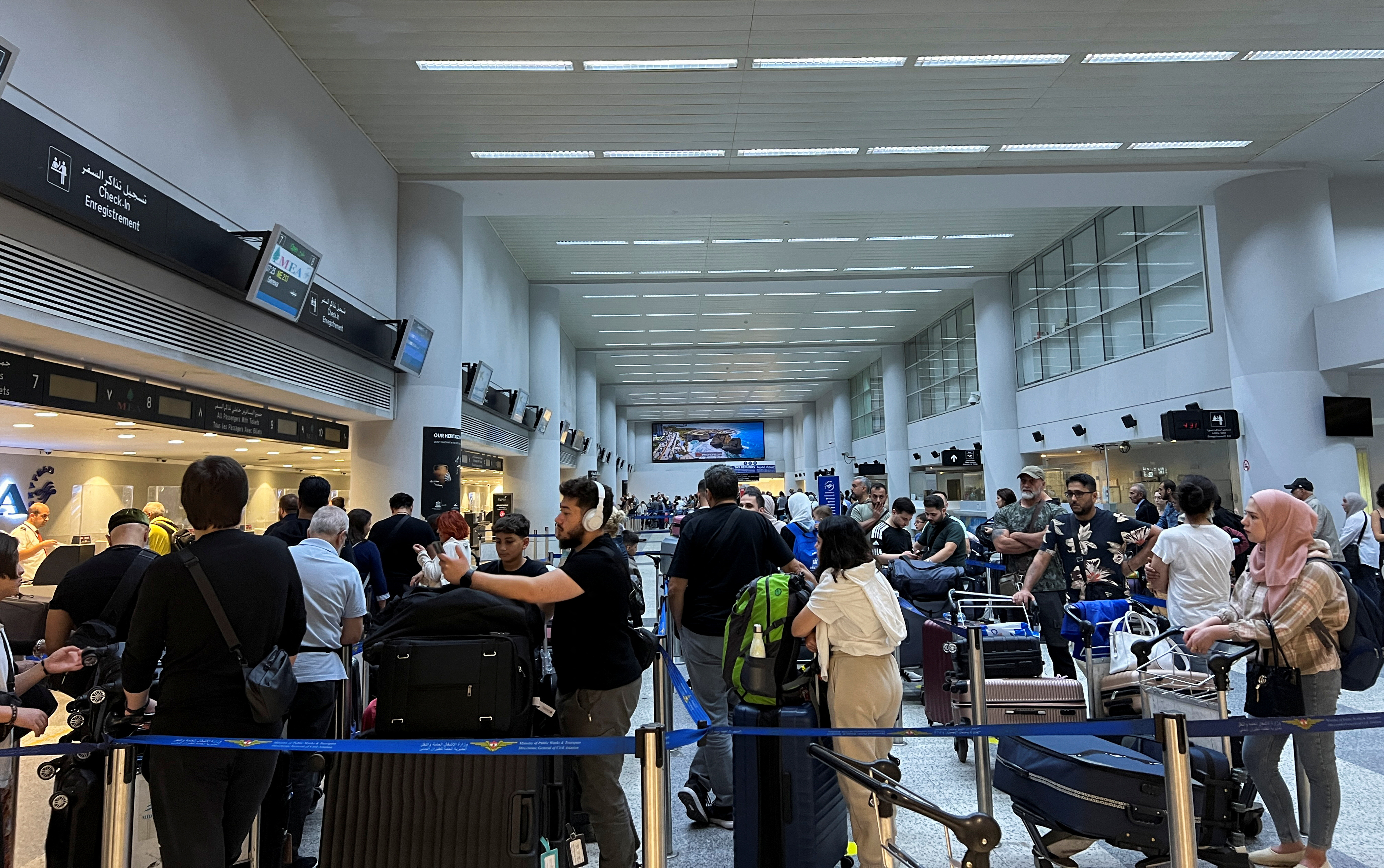 Passengers queue at the check-in counters at Beirut-Rafic Al Hariri International Airport