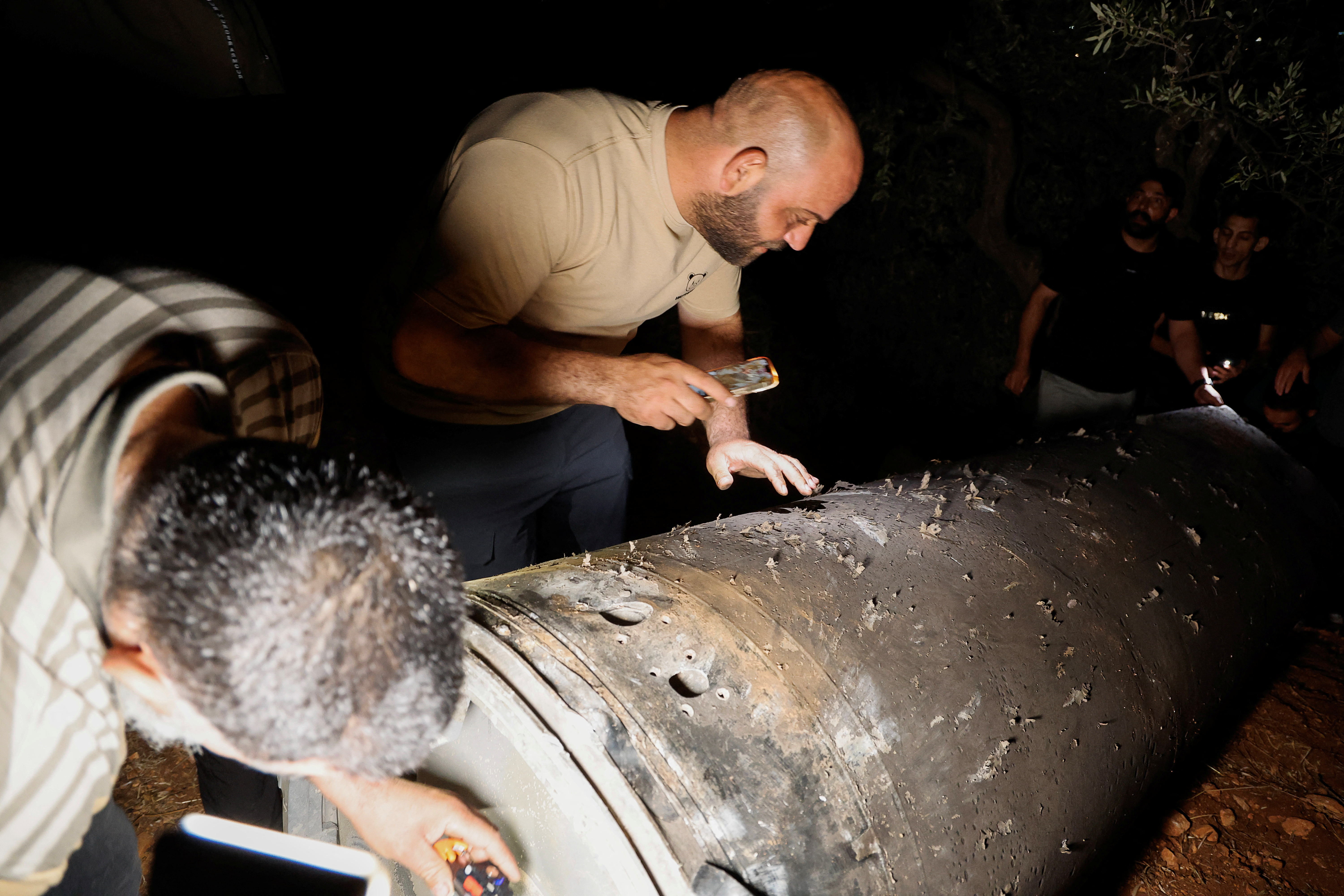 Palestinians investigate a projectile, after Iran fired a salvo of ballistic missiles, in Tubas