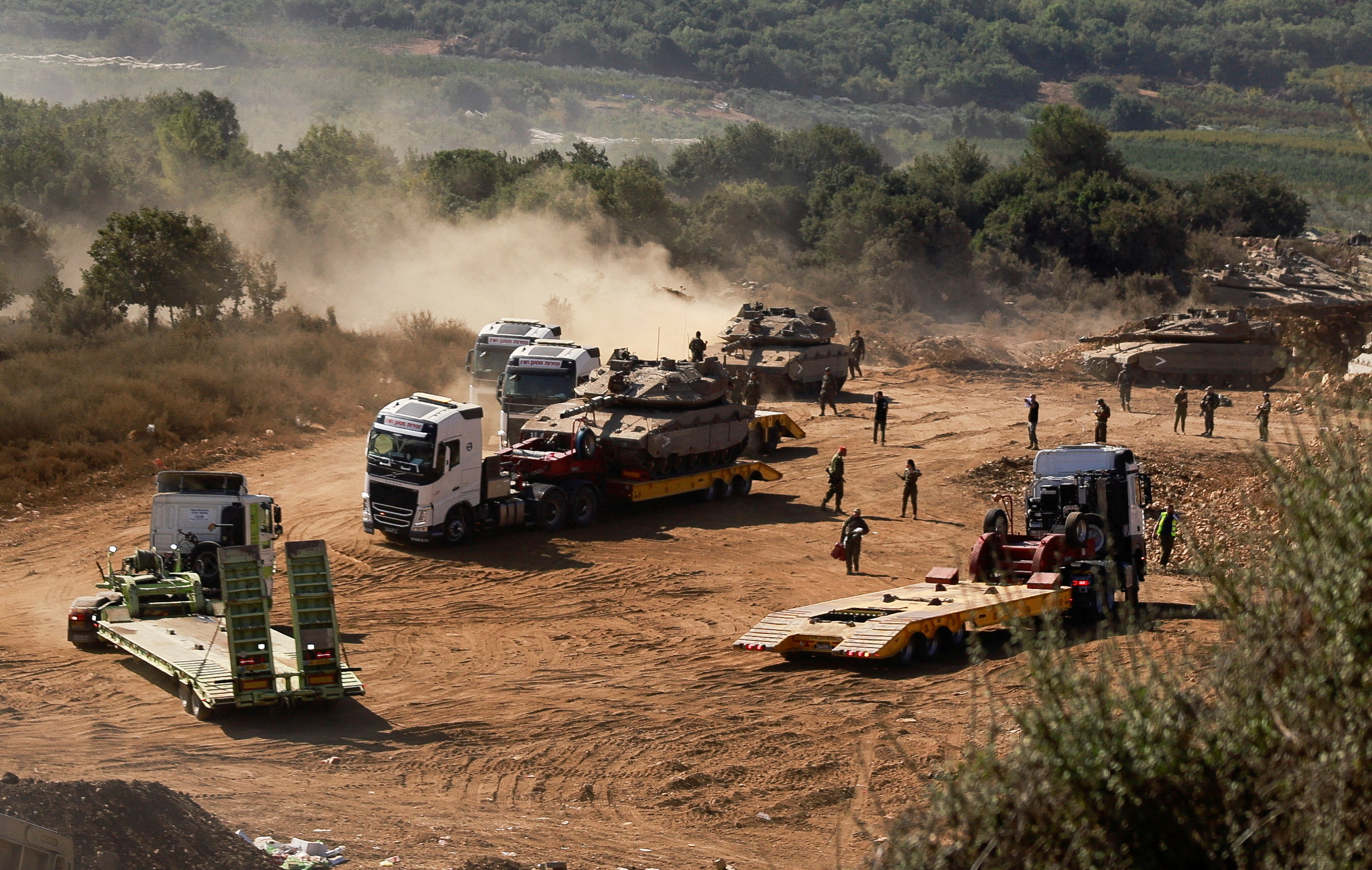 An Israeli Army tank is transported, amid ongoing cross-border hostilities between Hezbollah and Israeli forces