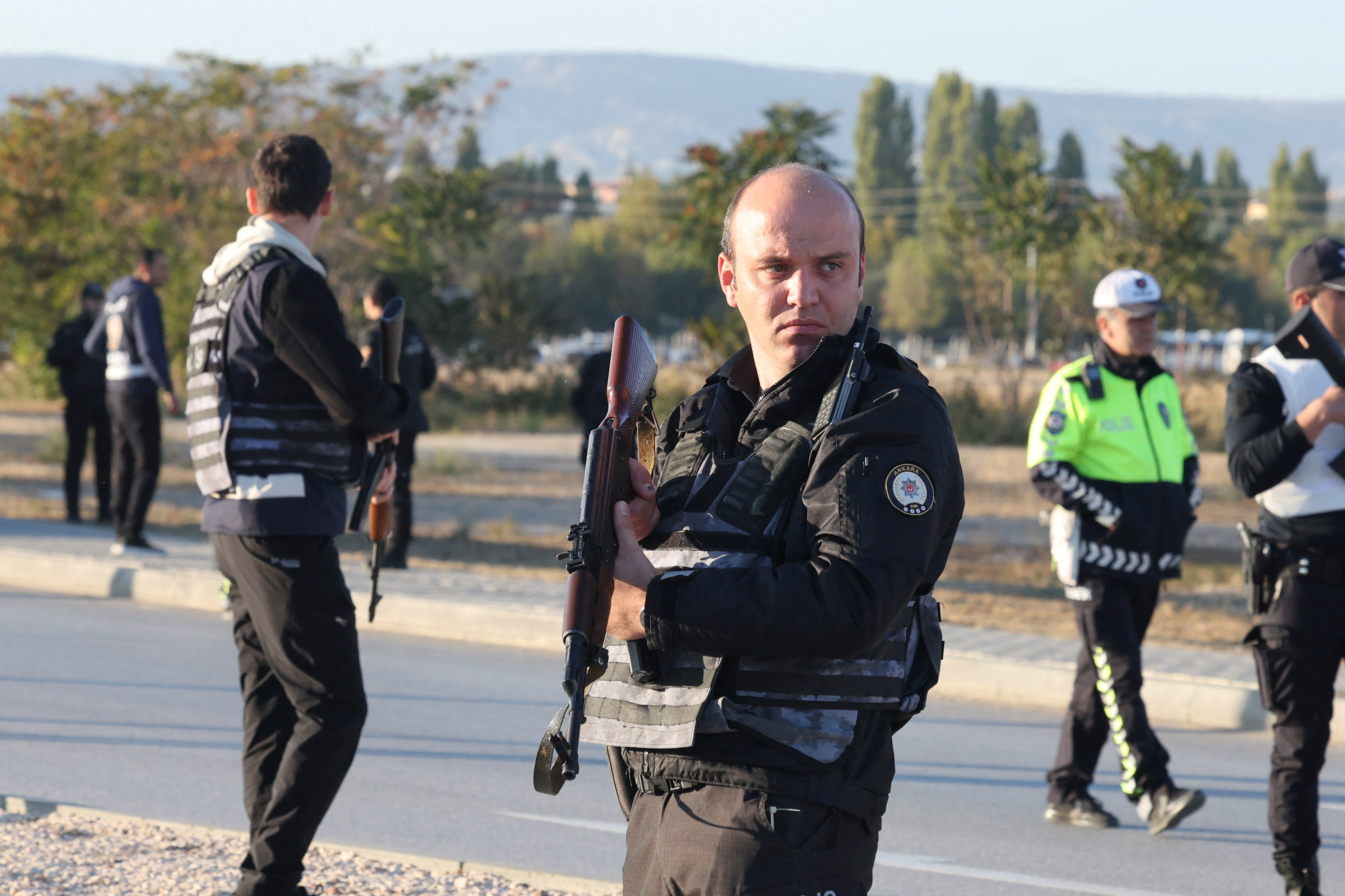 Police and private security guards secure the entrance of the headquarters of Turkey's aviation company TUSAS in Ankara