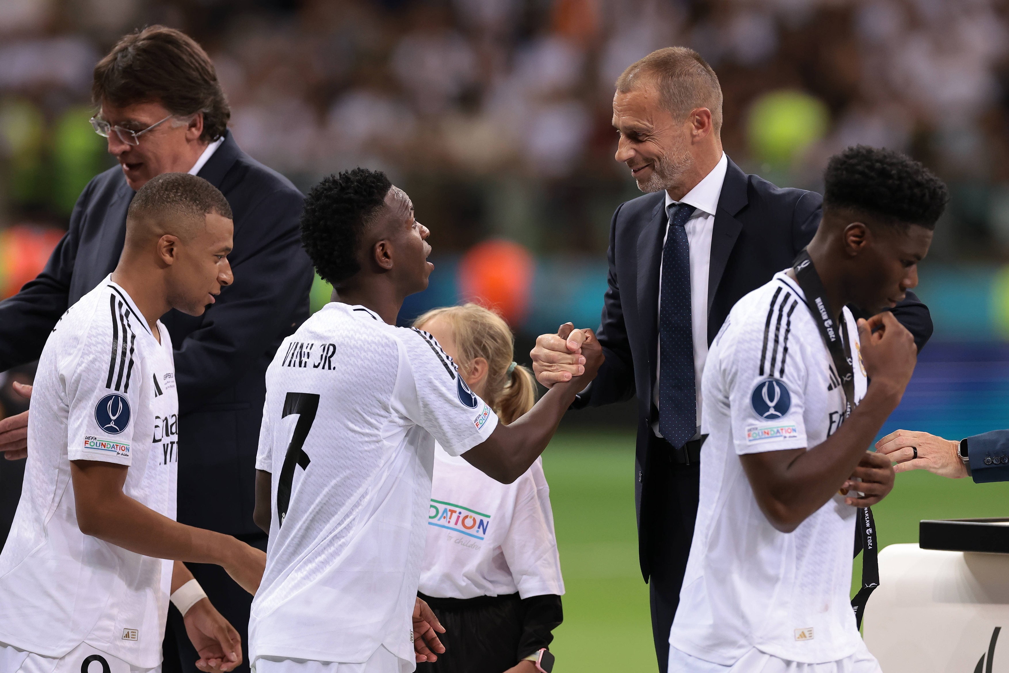 Warsaw, Poland, 14th August 2024. Kylian Mbappe of Real Madrid reacts as UEFA President Aleksander Ceferin shakes hands