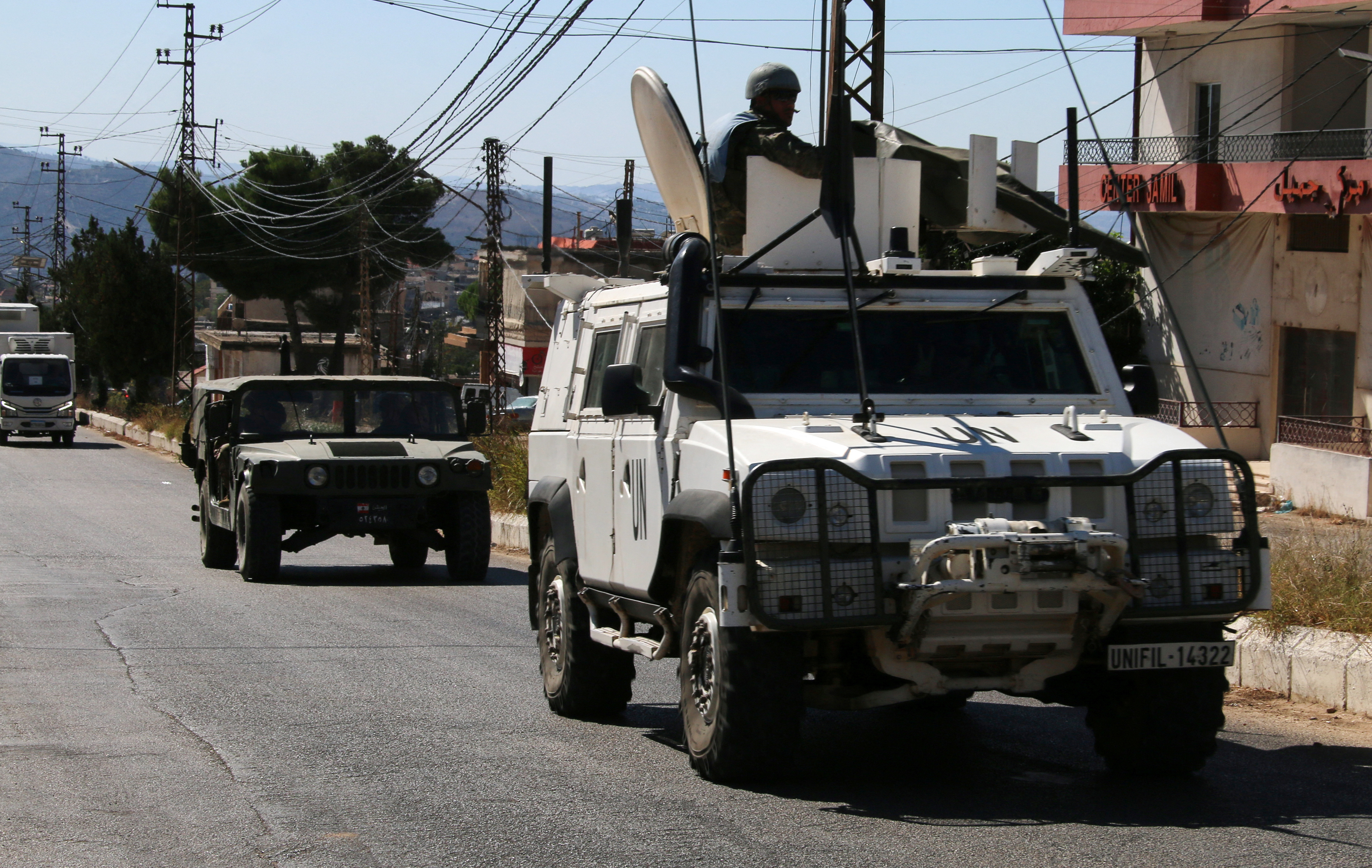 United Nations peacekeepers (UNIFIL) and Lebanese army vehicles drive in the town of Qlayaa