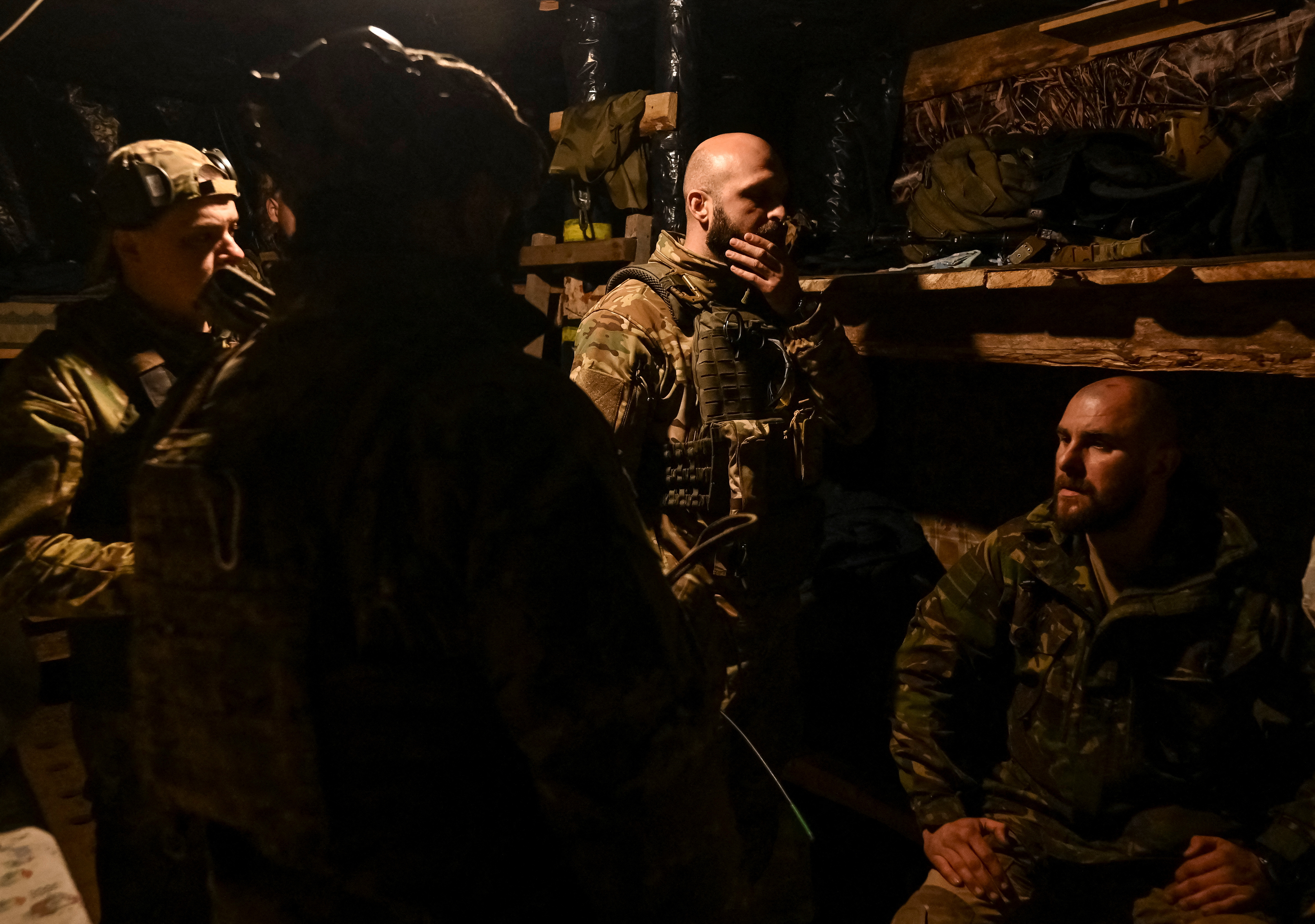 Ukrainian service members from the special police rest in a dugout near the frontline city of Toretsk