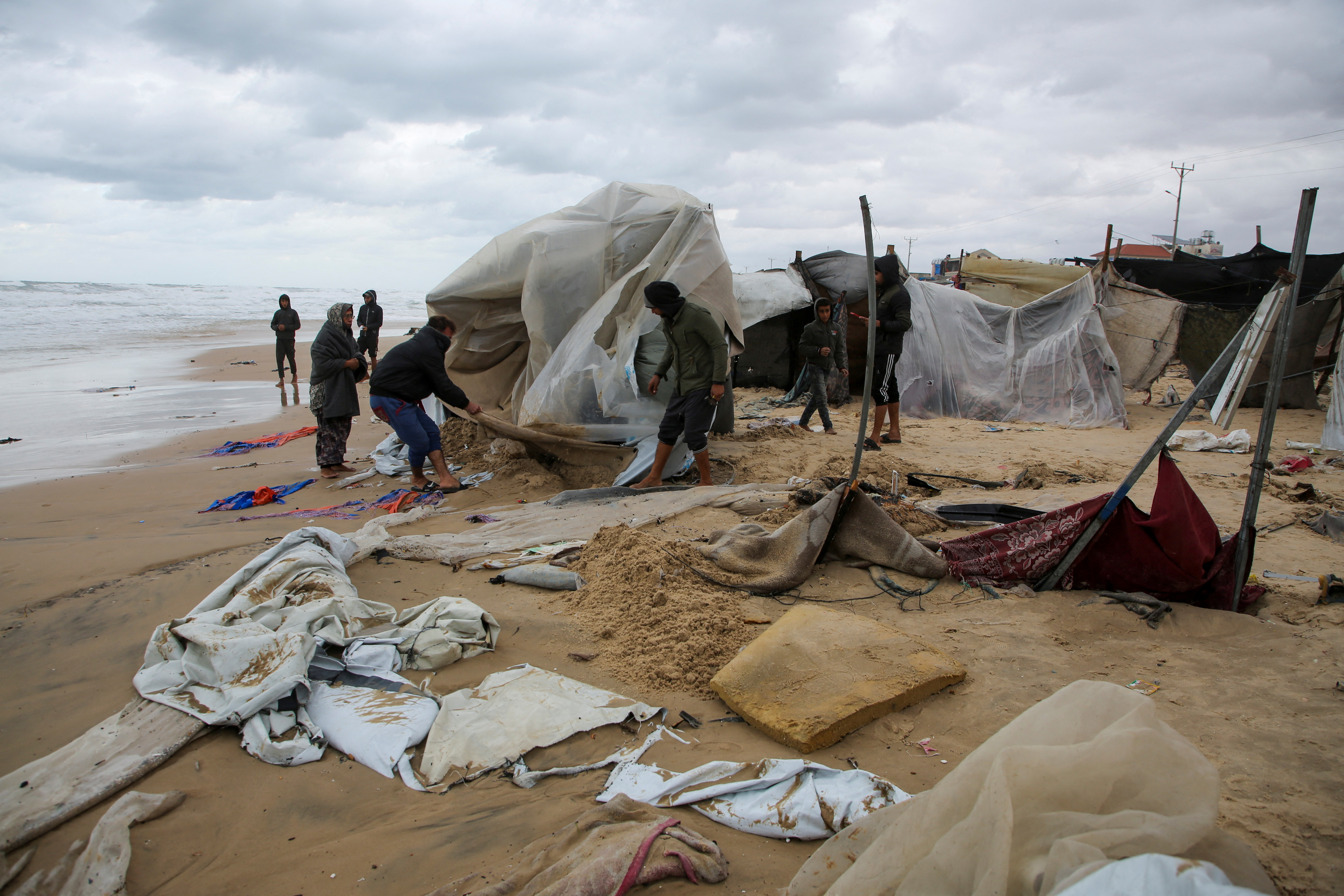 Heavy rains and rising sea levels flood the tents of displaced Palestinians in Gaza's Khan Younis