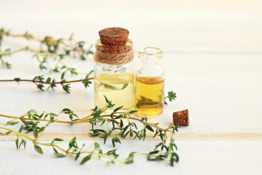Thyme,Essential,Oil.,In,Bottles,,With,Fresh,Thyme,Herb,Twigs.