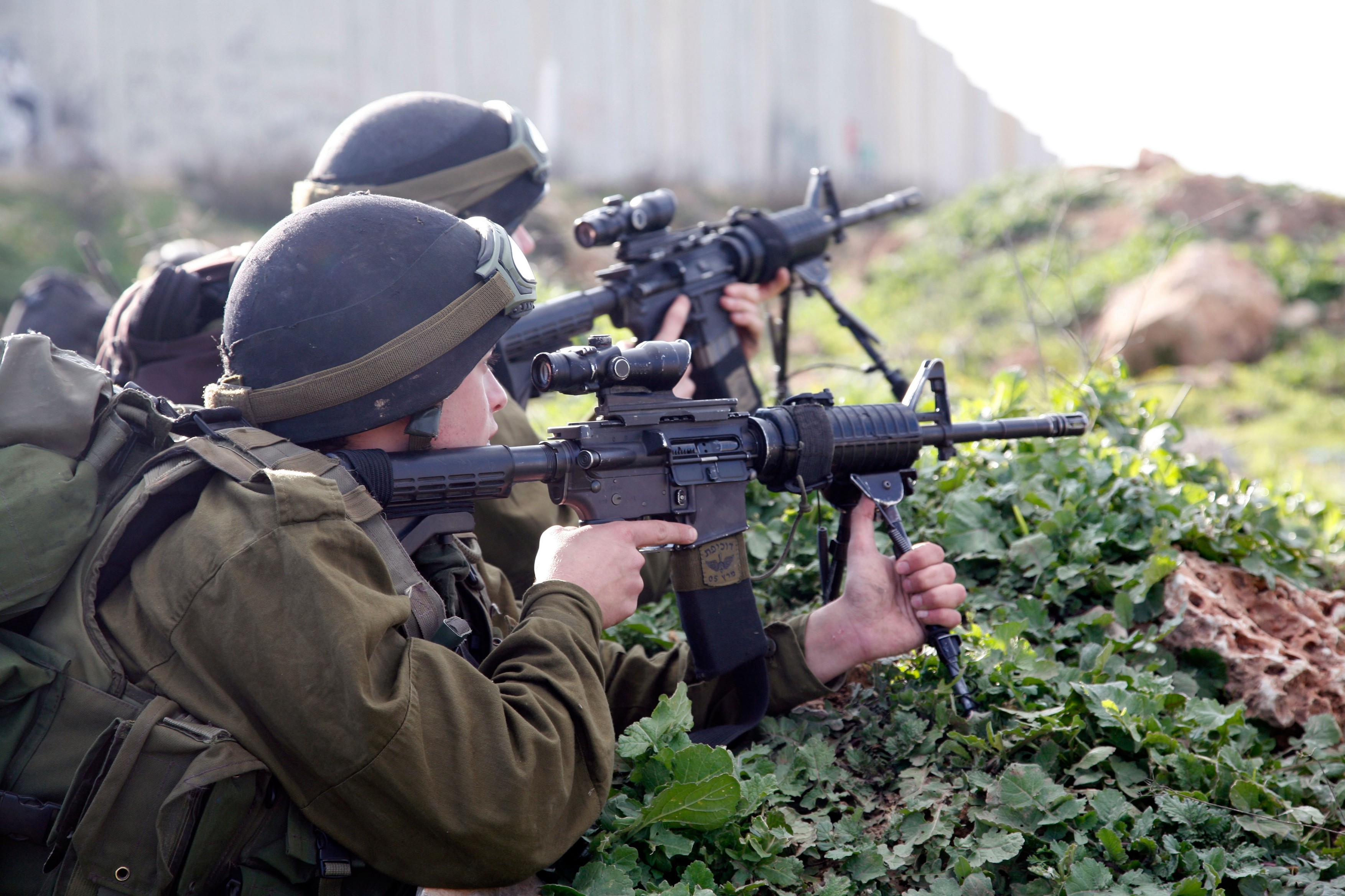Israeli soldiers shooting rubber bullets at Palestinian stone throwers near the separation barrier at Qalandiya in the West Bank