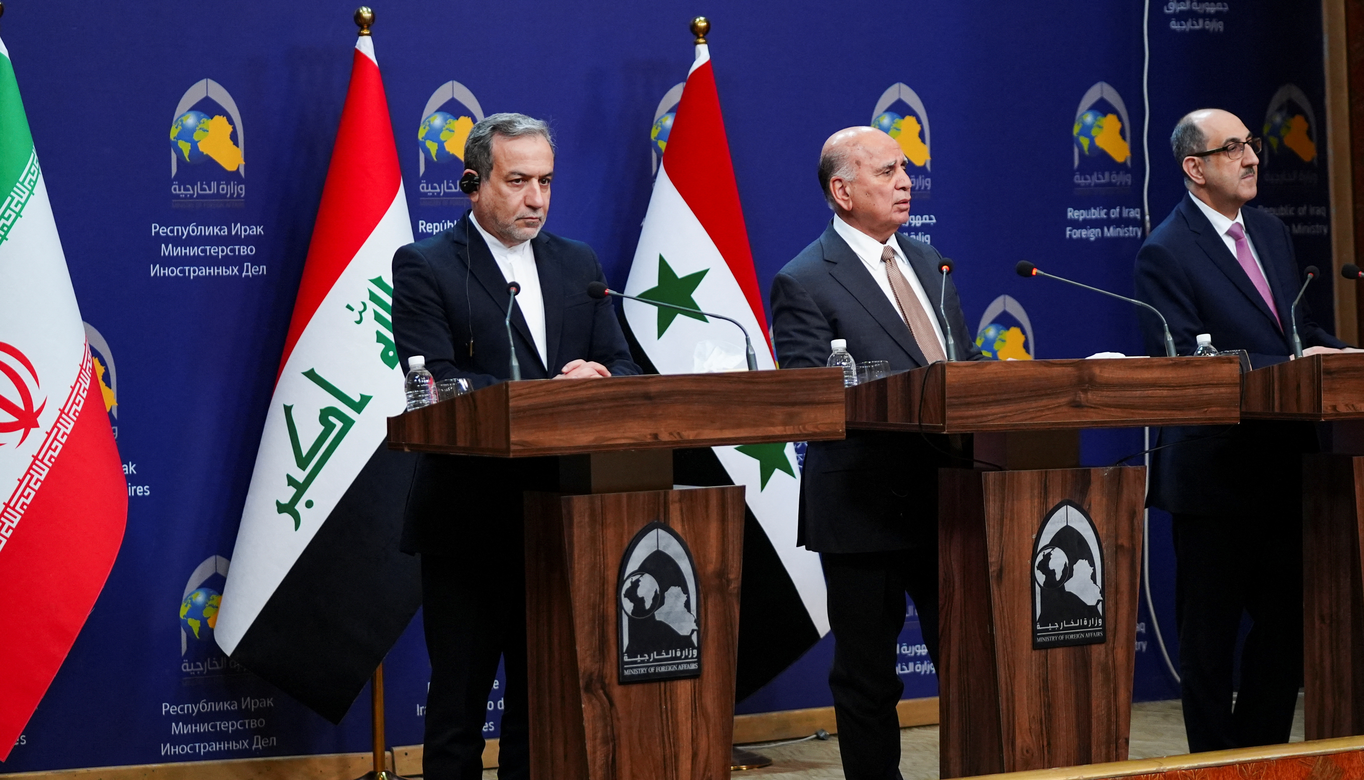 Iraqi Foreign Minister Fuad Hussein speaks during a news conference as Syrian foreign minister Bassam Sabbagh and Iranian Foreign Minister Abbas Araghchi stand, in Baghdad
