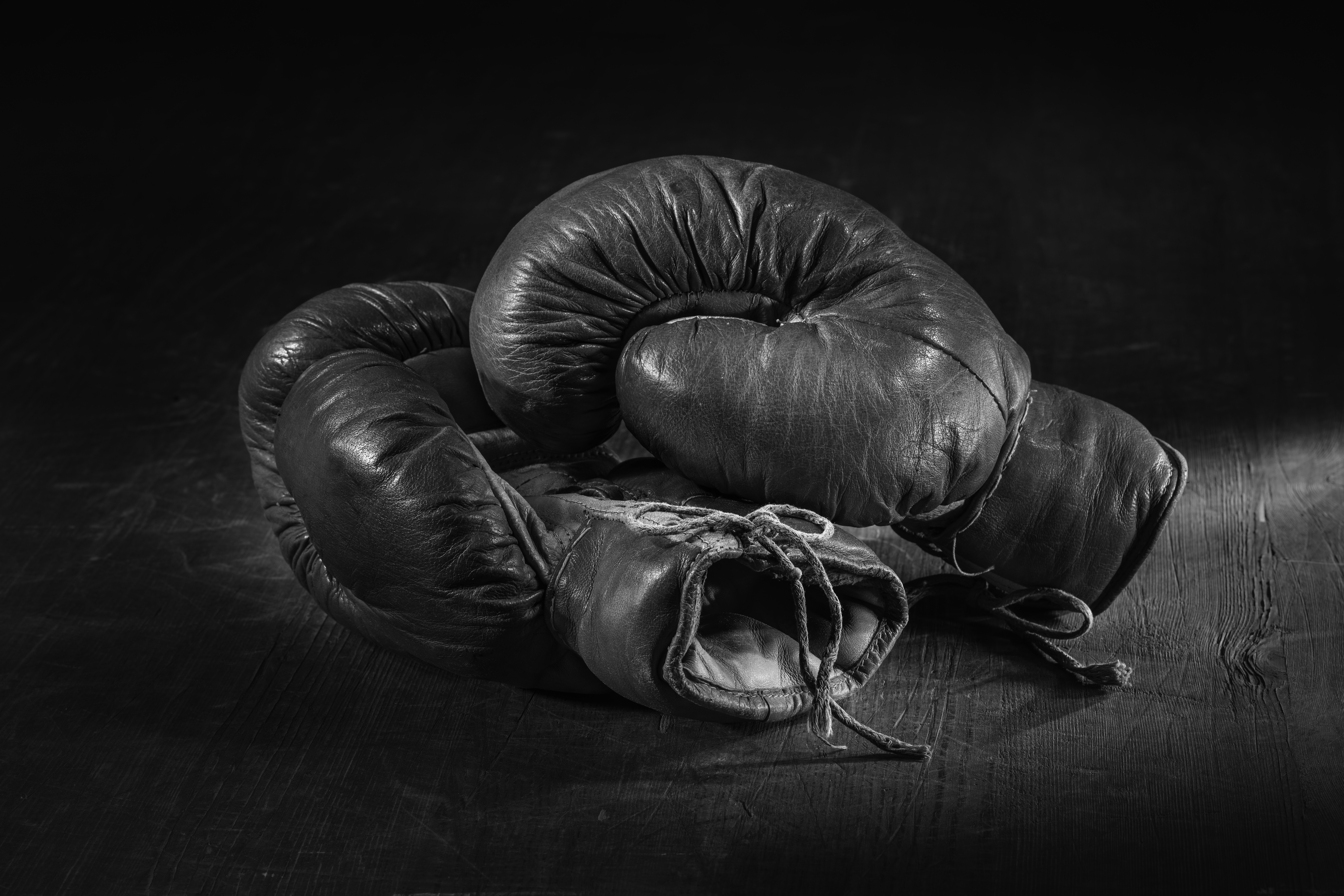 Old,Red,Boxing,Gloves,On,Wooden,Background.