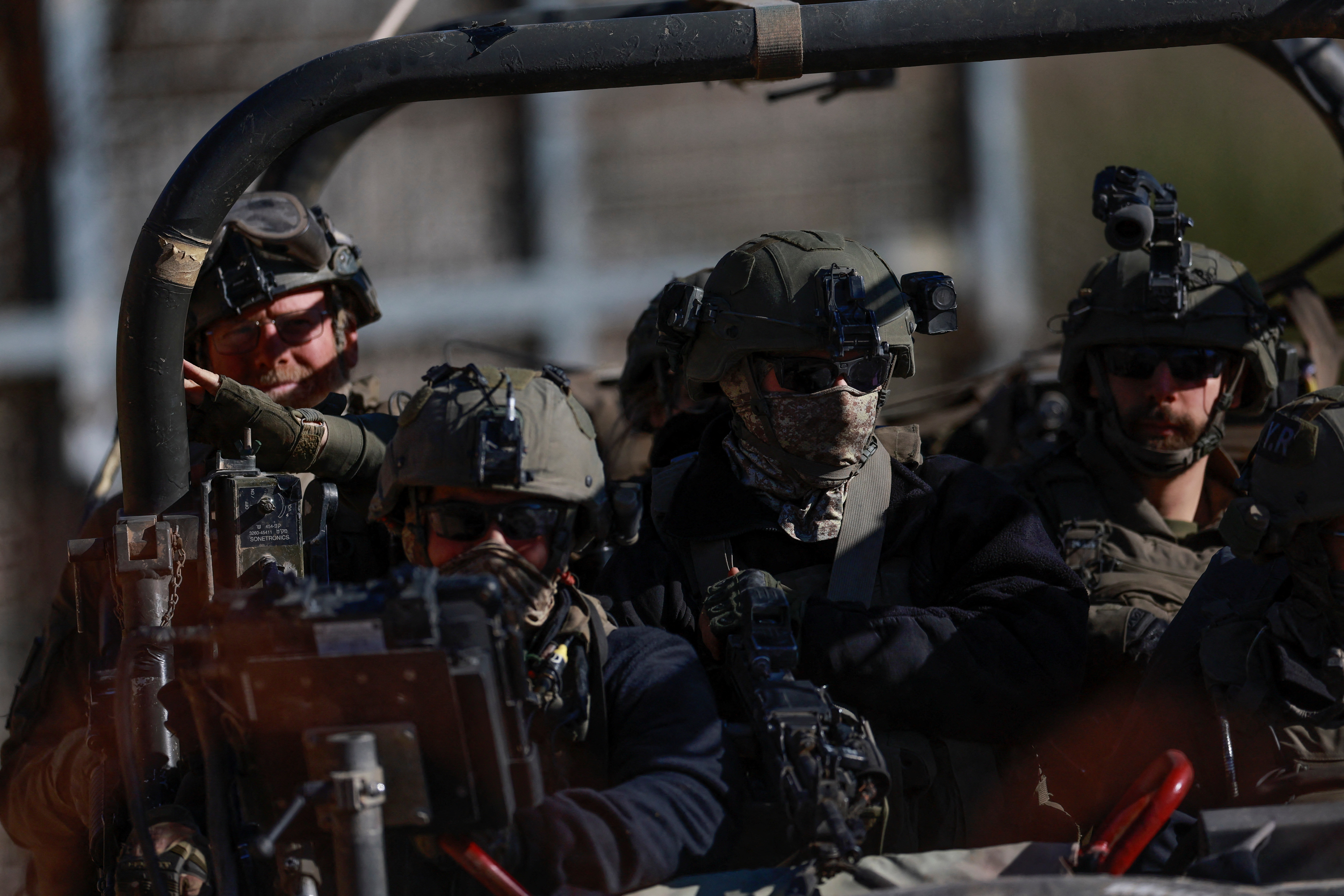 Israeli soldiers gather near the ceasefire line between Syria and the Israeli-occupied Golan Heights