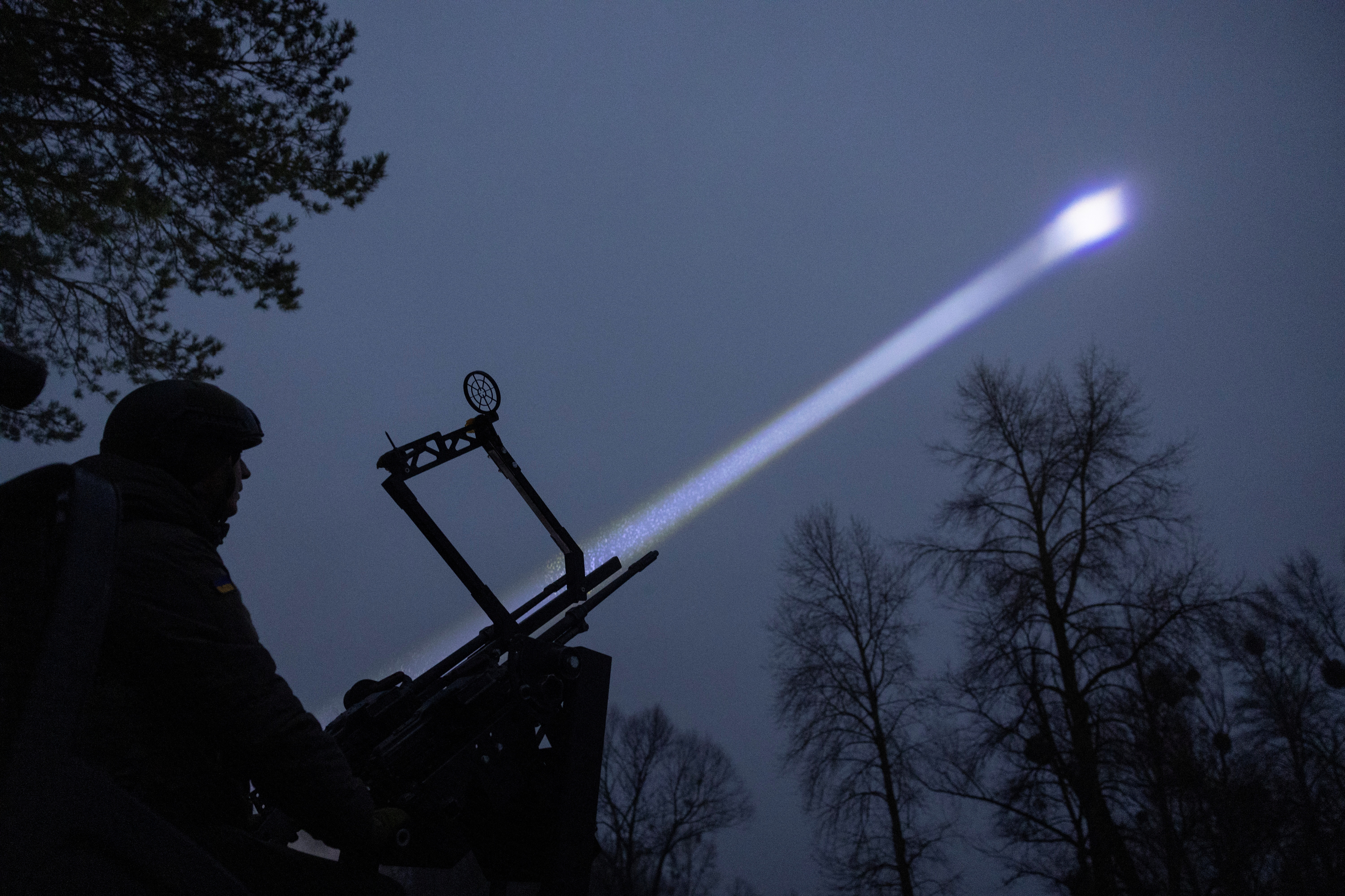 Judge and spokesperson of Bila Tserkva district court Vladyslav Tsukurov observes the sky during a combat shift of his air defence volunteer unit in Kyiv region