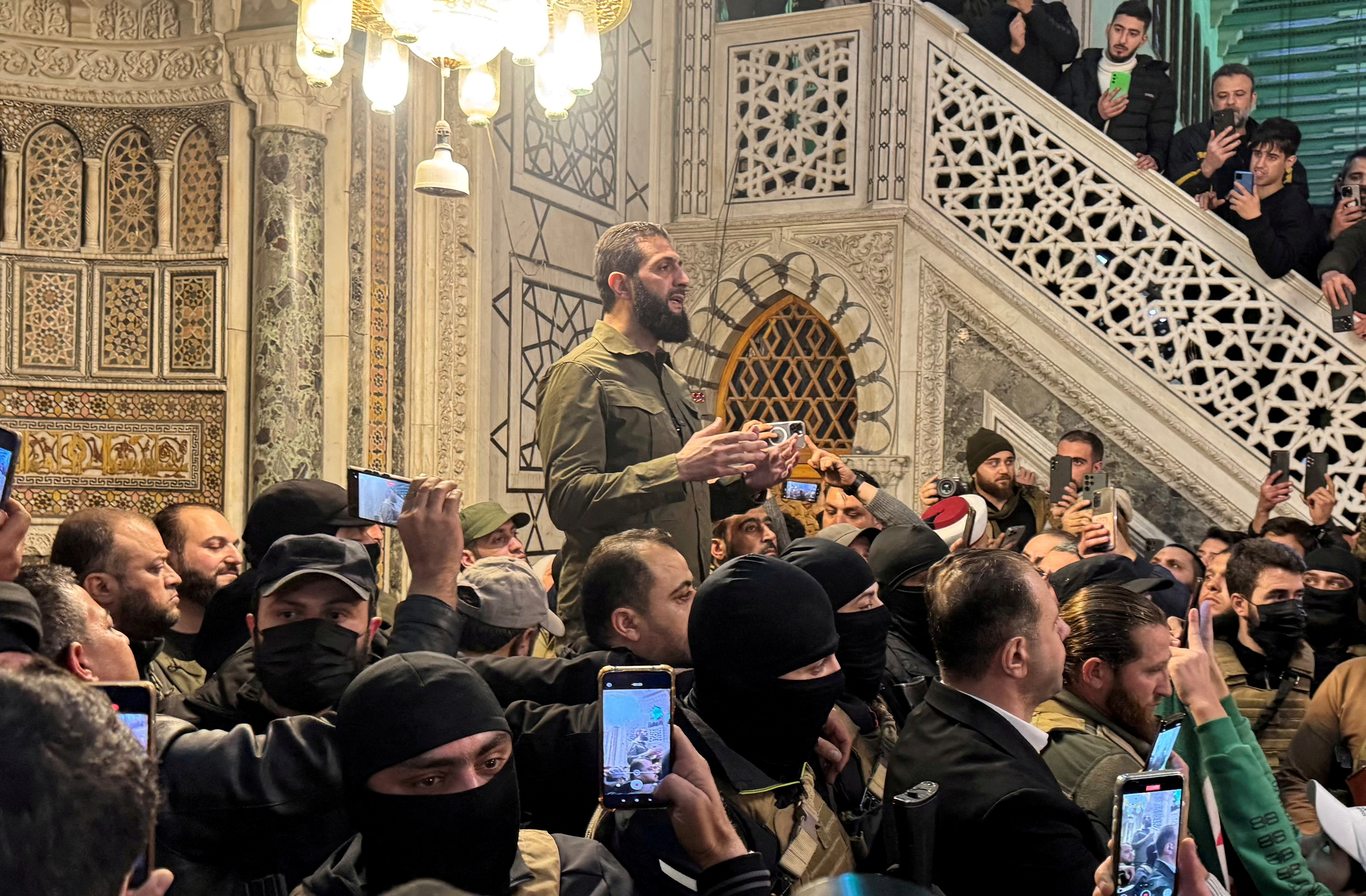 FILE PHOTO: Top rebel commander Abu Mohammed al-Golani speaks to a crowd at Ummayad Mosque in Damascus