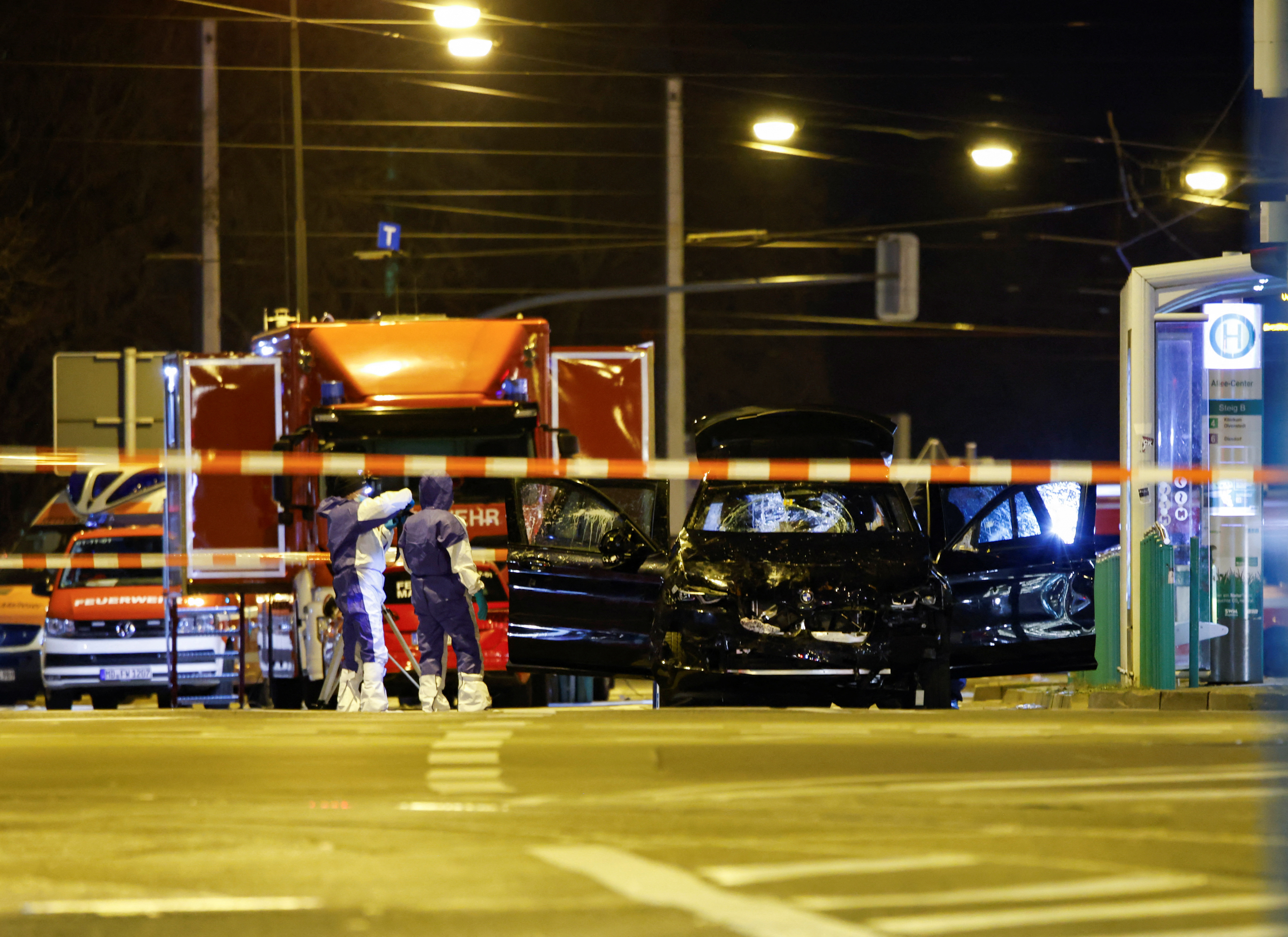Emergency personnel work next to a damaged car that drove into a group of people, according to local media, in Magdeburg