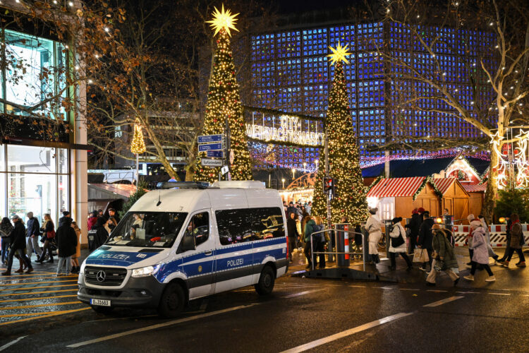 A police car secures an entrance of the Christmas market on the Breitscheidplatz, in Berlin