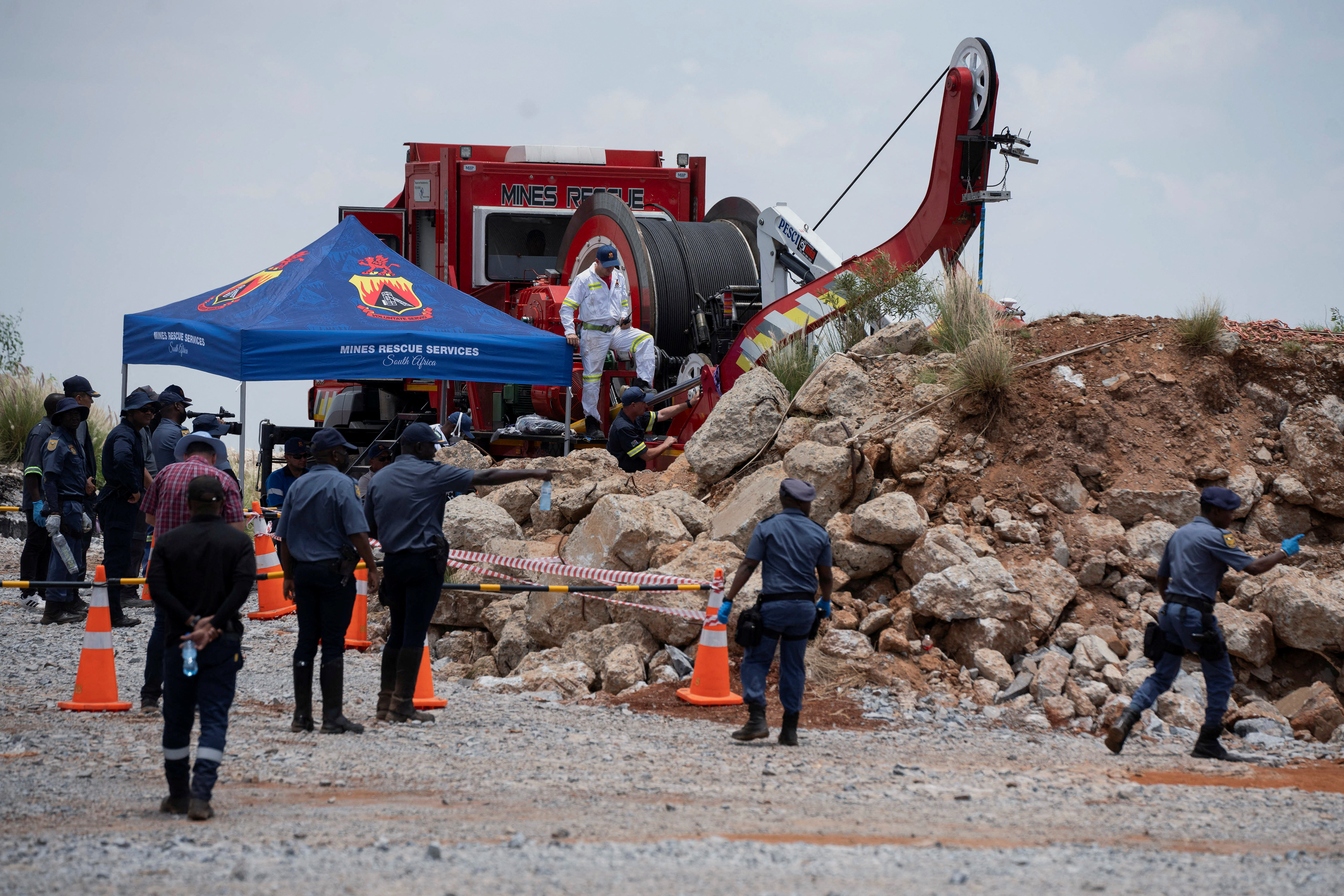 Members of the South African police, patrol as they guard the mine shaft where rescue operations are ongoing as attempts are made to rescue illegal miners who have been underground for months in Stilfontein