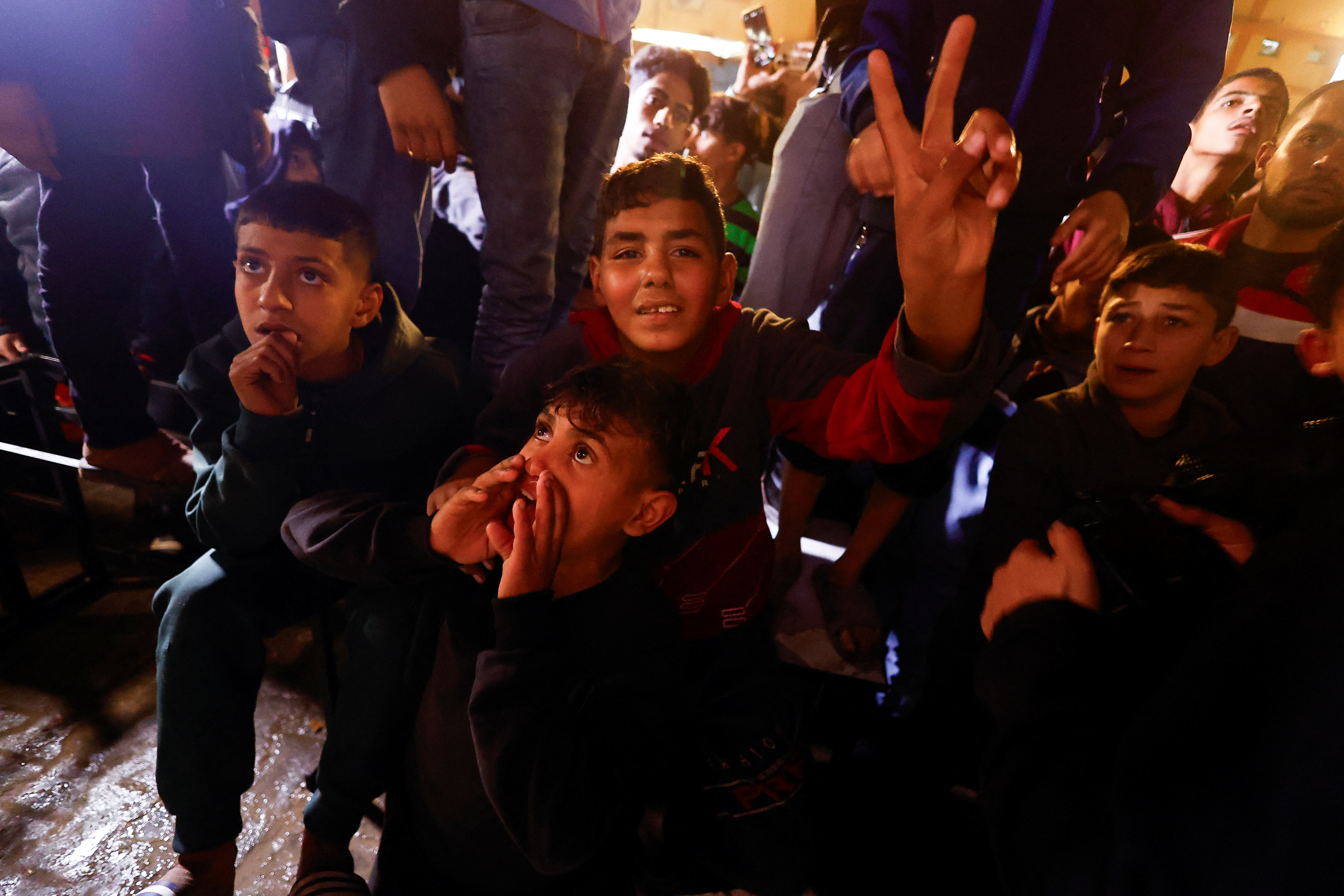Palestinians react as they wait for news of a ceasefire deal with Israel, in Khan Younis in the southern Gaza Strip