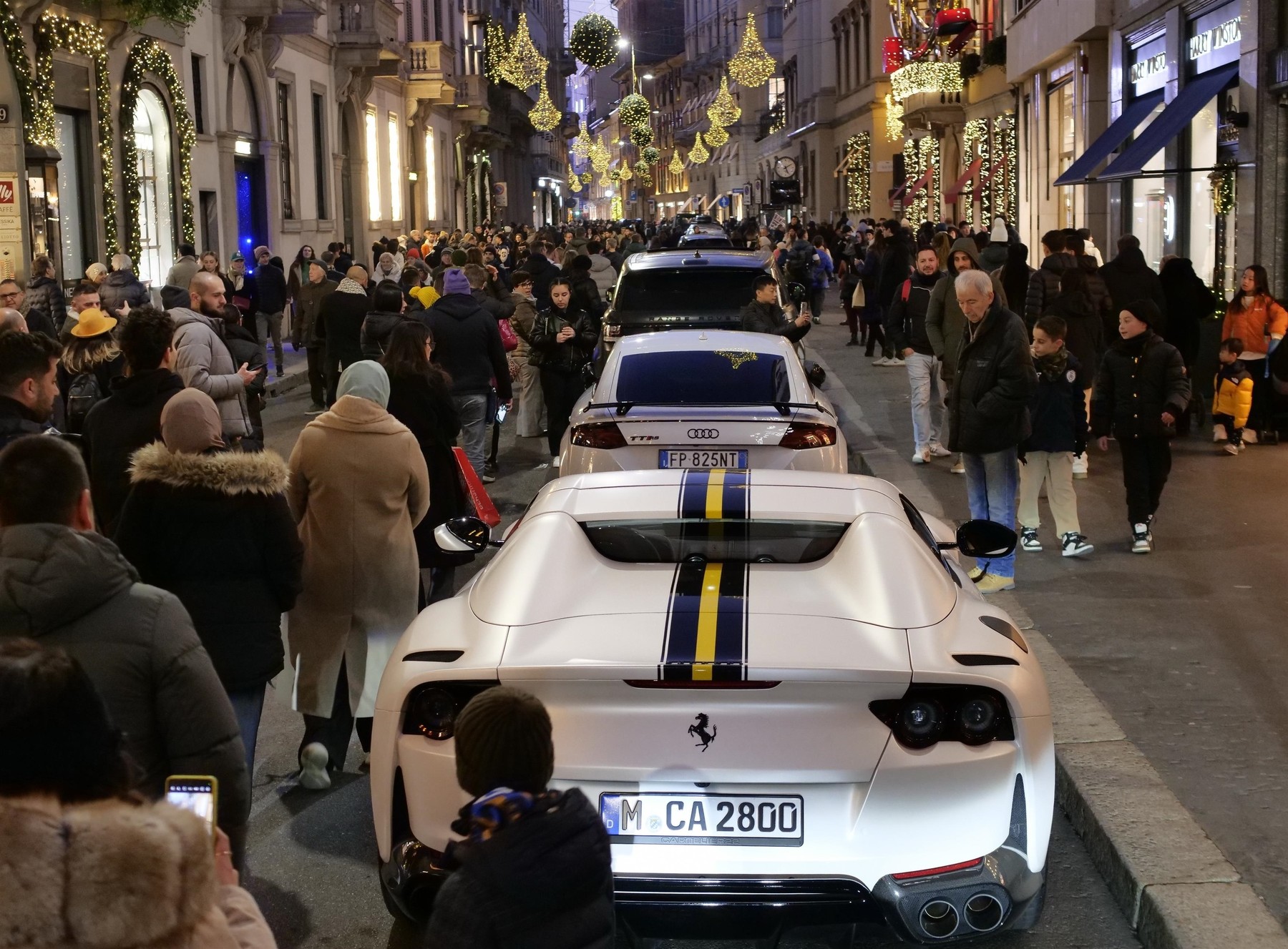 Via Montenapoleone in Milan, one of the city's most prestigious shopping streets, is bustling with activity in the final hours of the year