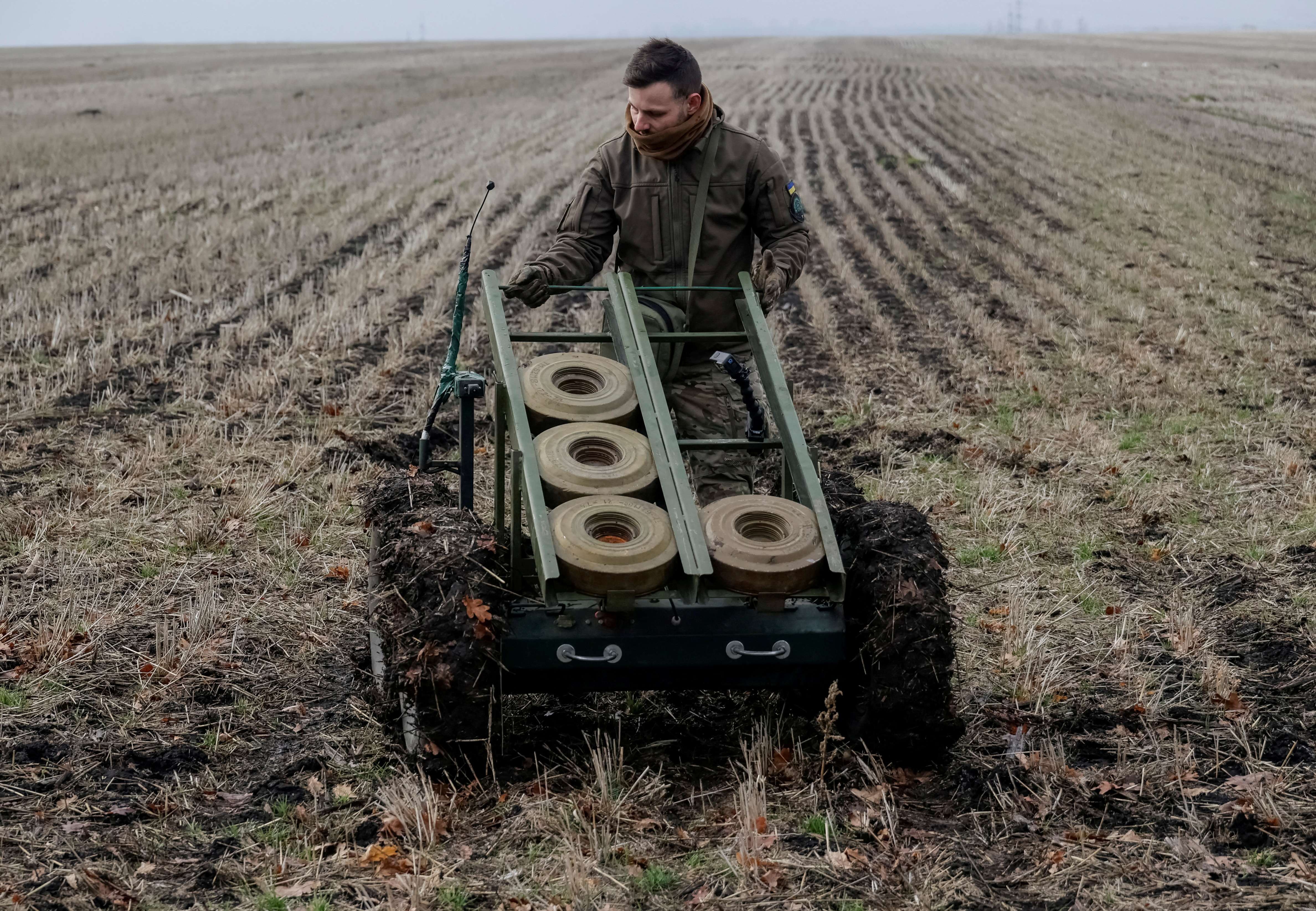 FILE PHOTO: A serviceman of the National Guard of Ukraine operates a mine-laying unmanned ground vehicle in Kharkiv region